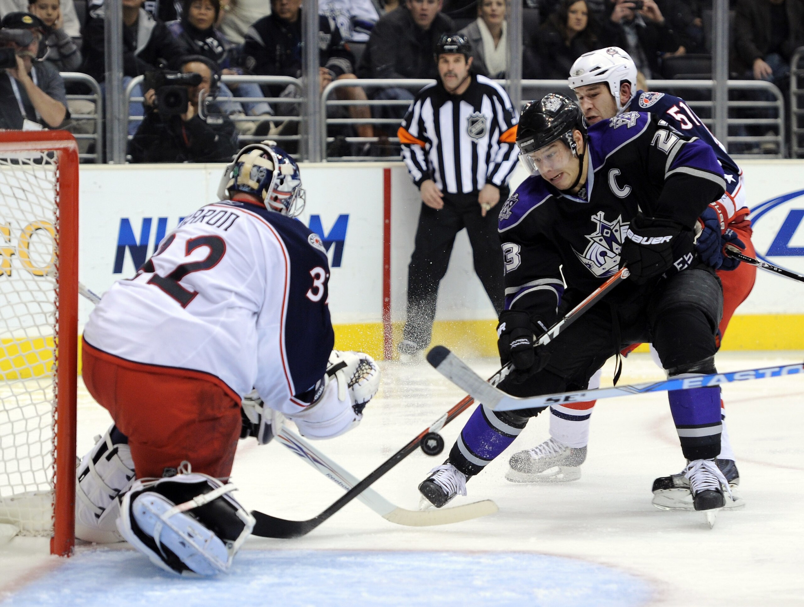 LOS ANGELES, CA - JANUARY 08: Dustin Brown #23 of the Los Angeles Kings breaks in on Mathieu Garon #32 and Fedor Tyutin #51 of the Columbus Blue Jackets during the second period at the Staples Center on January 8, 2011 in Los Angeles, California. (Phot LOS ANGELES, CA - JANUARY 08: Dustin Brown #23 of the Los Angeles Kings breaks in on Mathieu Garon #32 and Fedor Tyutin #51 of the Columbus Blue Jackets during the second period at the Staples Center on January 8, 2011 in Los Angeles, California. (Phot