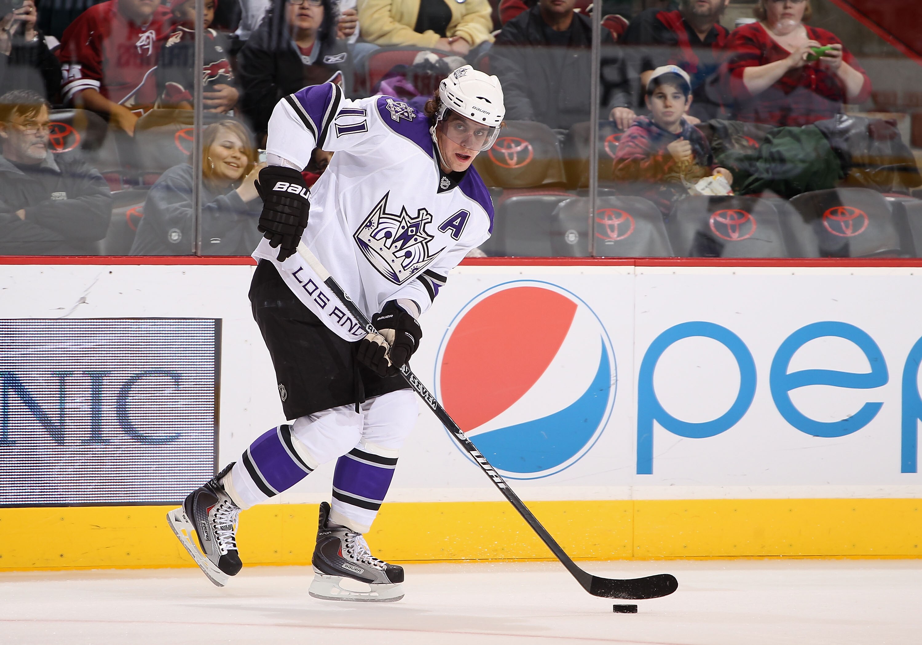 GLENDALE, AZ - DECEMBER 29:  Anze Kopitar #11 of the Los Angeles Kings skates with the puck during the NHL game against the Phoenix Coyotes at Jobing.com Arena on December 29, 2010 in Glendale, Arizona.  The Coyotes defeated the Kings 6-3.  (Photo by Chri