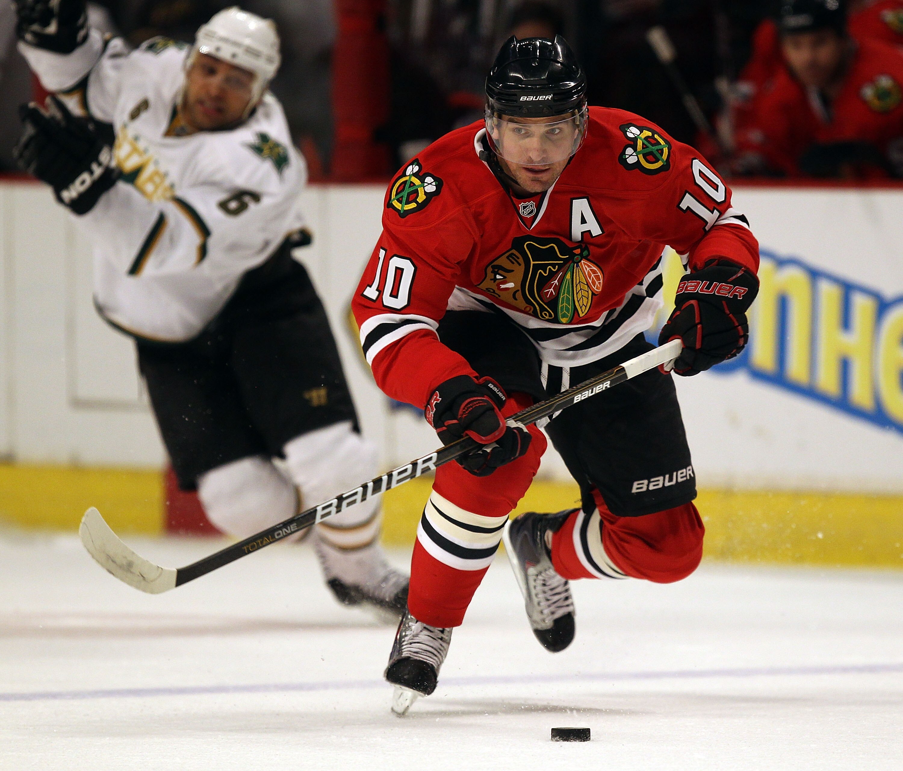 CHICAGO, IL - JANUARY 05: Patrick Sharp #10 of the Chicago Blackhawks chases down the puck after Trevor Daley #6 of the Dallas Stars looses his balance at the United Center on January 5, 2011 in Chicago, Illinois. The Stars defeated the Blackhawks 4-2. (P