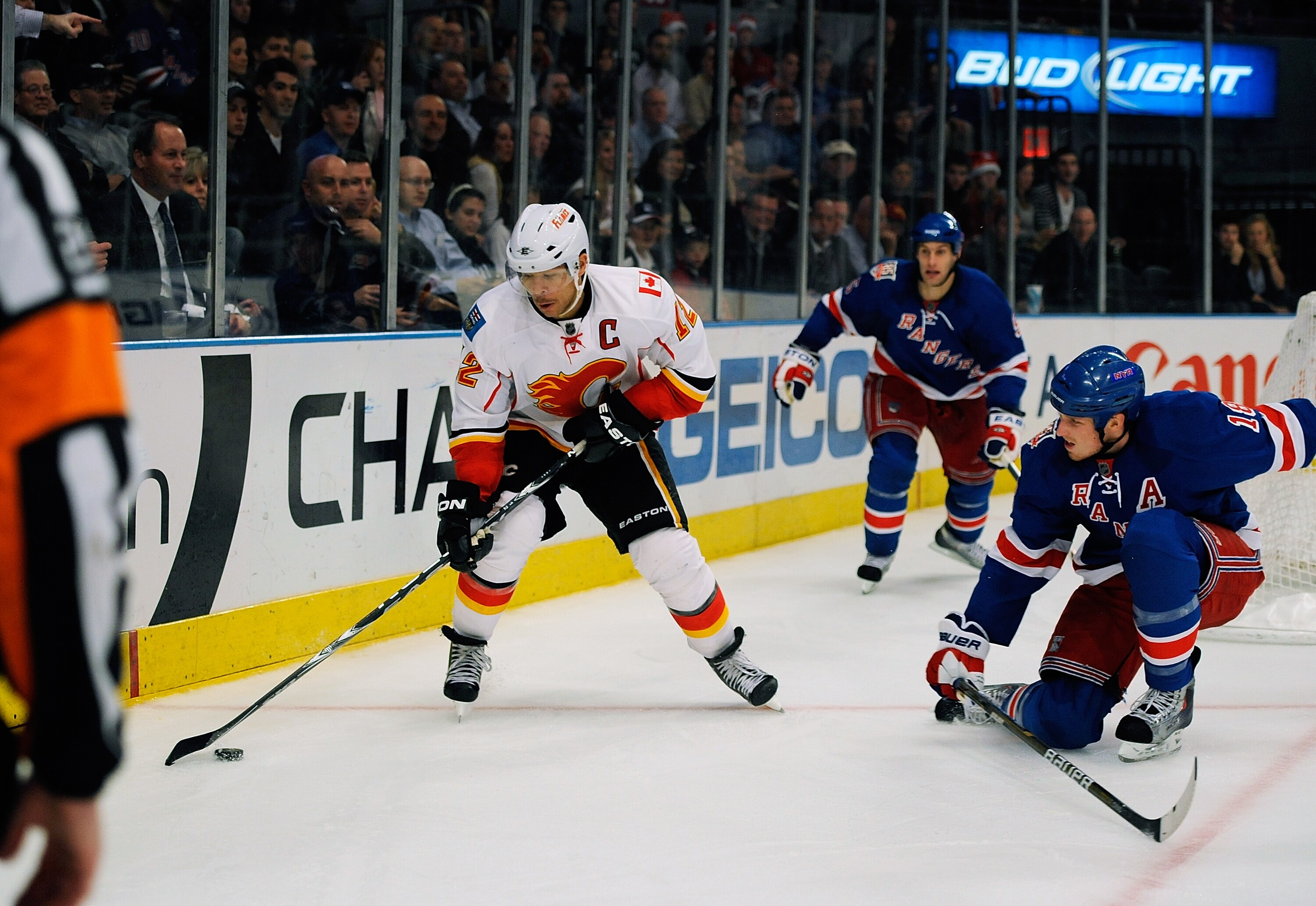 NEW YORK - NOVEMBER 22:  Jerome Iginla #12 of the Calgary Flames with the puck the puck defended by Marc Staal #18 the New York Rangers on November 22, 2010 at Madison Square Garden in New York City.  (Photo by Lou Capozzola/Getty Images)