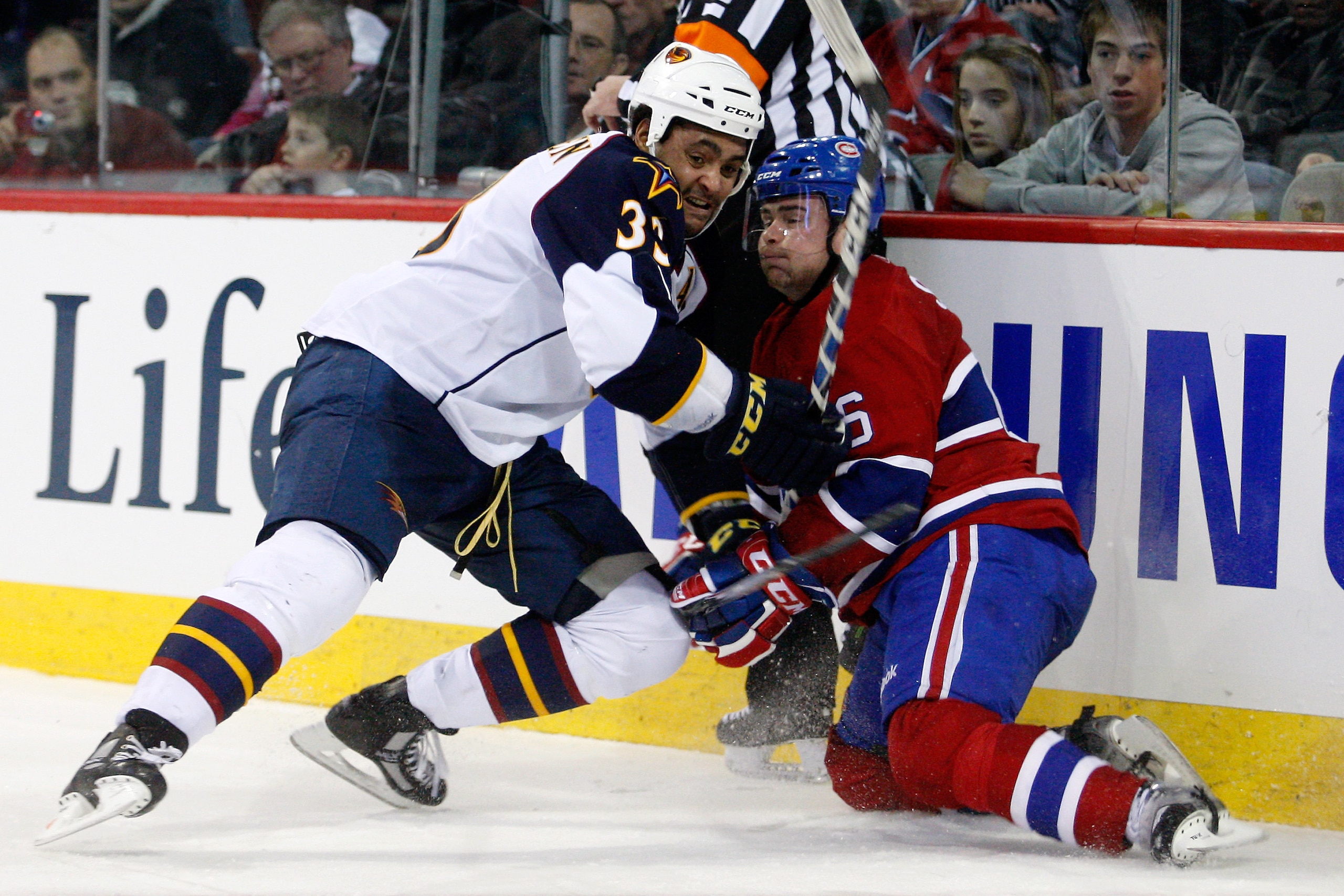 MONTREAL, CANADA - JANUARY 2: Dustin Byfuglien #33 of the Atlanta Thrashers body checks Jaroslav Spacek #6 of the Montreal Canadiens during the NHL game at the Bell Centre on January 2, 2011 in Montreal, Quebec, Canada. The Thrashers defeated the Canadi MONTREAL, CANADA - JANUARY 2: Dustin Byfuglien #33 of the Atlanta Thrashers body checks Jaroslav Spacek #6 of the Montreal Canadiens during the NHL game at the Bell Centre on January 2, 2011 in Montreal, Quebec, Canada. The Thrashers defeated the Canadi