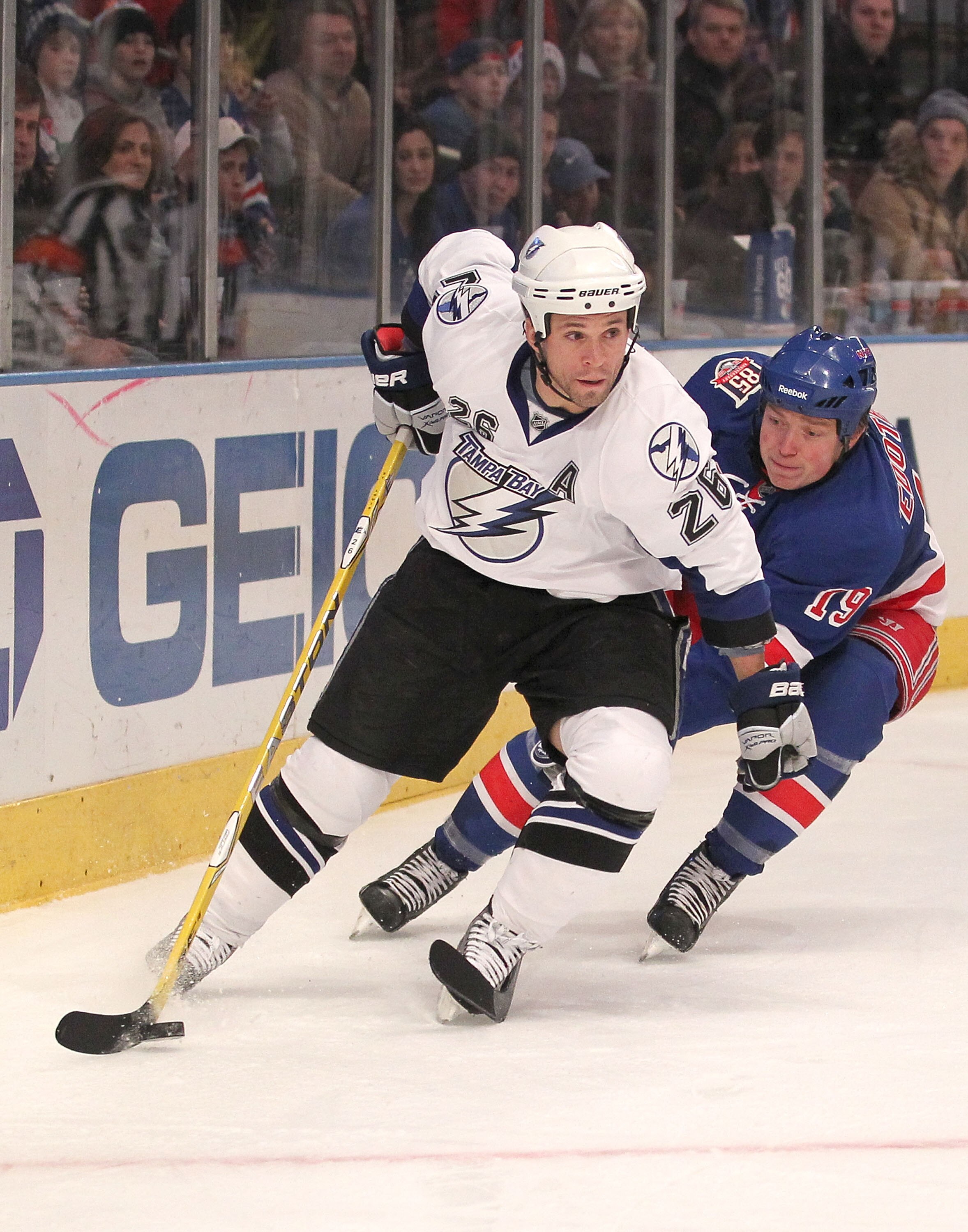 NEW YORK, NY - DECEMBER 23:  Ruslan Fedotenko #19 of the New York Rangers tries to stop Martin St. Louis #26 of the Tampa Bay Lightning during the third period of an NHL hockey game at Madison Square Garden on December 23, 2010 in New York City.  (Photo b