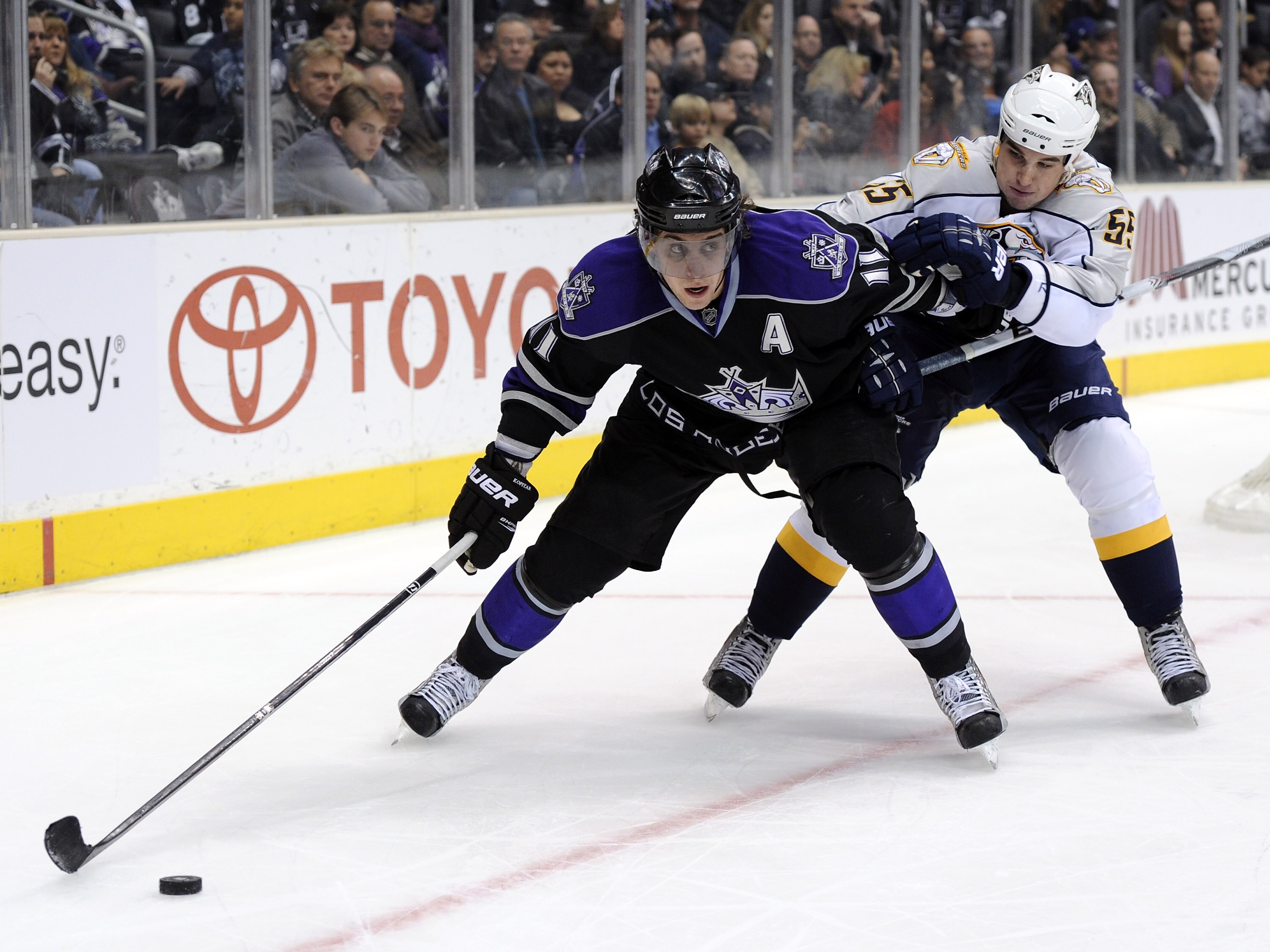 LOS ANGELES, CA - JANUARY 06:  Anze Kopitar #11 of the Los Angeles Kings keeps Shane O'Brien #55 of the Nashville Predators from the puck as he looks to make a play during the game at the Staples Center on January 6, 2011 in Los Angeles, California.  (Pho