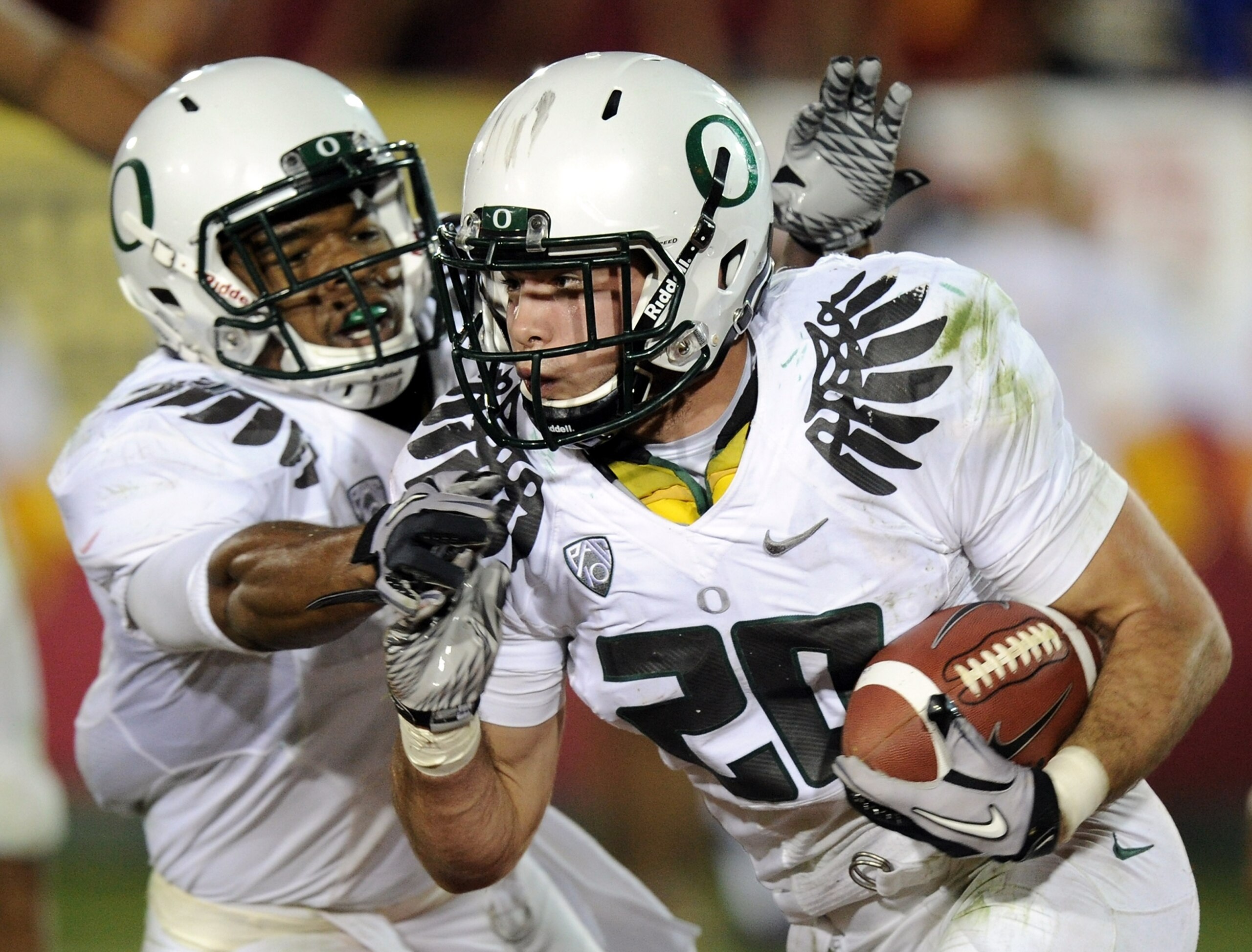 LOS ANGELES, CA - OCTOBER 30:  John Boyett #20 of the Oregon Ducks reacts to his interception with Eddie Pleasant on their way to a 53-32 win over the USC Trojans at Los Angeles Memorial Coliseum on October 30, 2010 in Los Angeles, California.  (Photo by