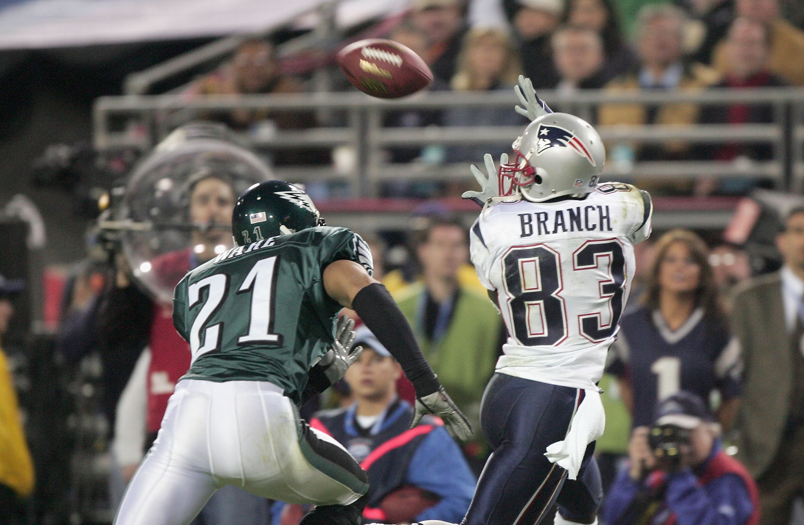 JACKSONVILLE, FL - FEBRUARY 6:  Wide receiver Deion Branch #83 of the New England Patriots receives a pass over Matt Ware #21 of the Philadelphia Eagles during Super Bowl XXXIX at Alltel Stadium on February 6, 2005 in Jacksonville, Florida. The Patriots d