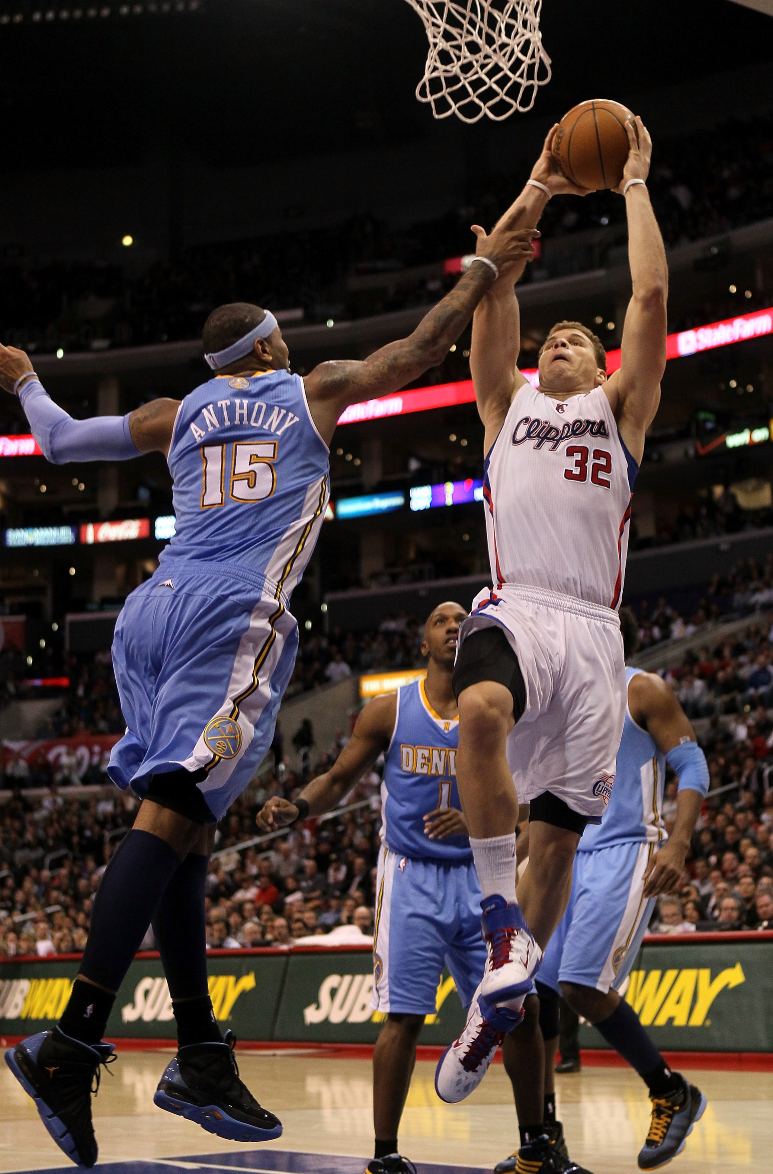 LOS ANGELES, CA - JANUARY 5:  Blake Griffin #32 of the Los Angeles Clippers goes up for a shot over Carmelo Anthony #15 of the Denver Nuggets at Staples Center on January 5, 2011  in Los Angeles, California. The Clippers won 106-93.  NOTE TO USER: User ex