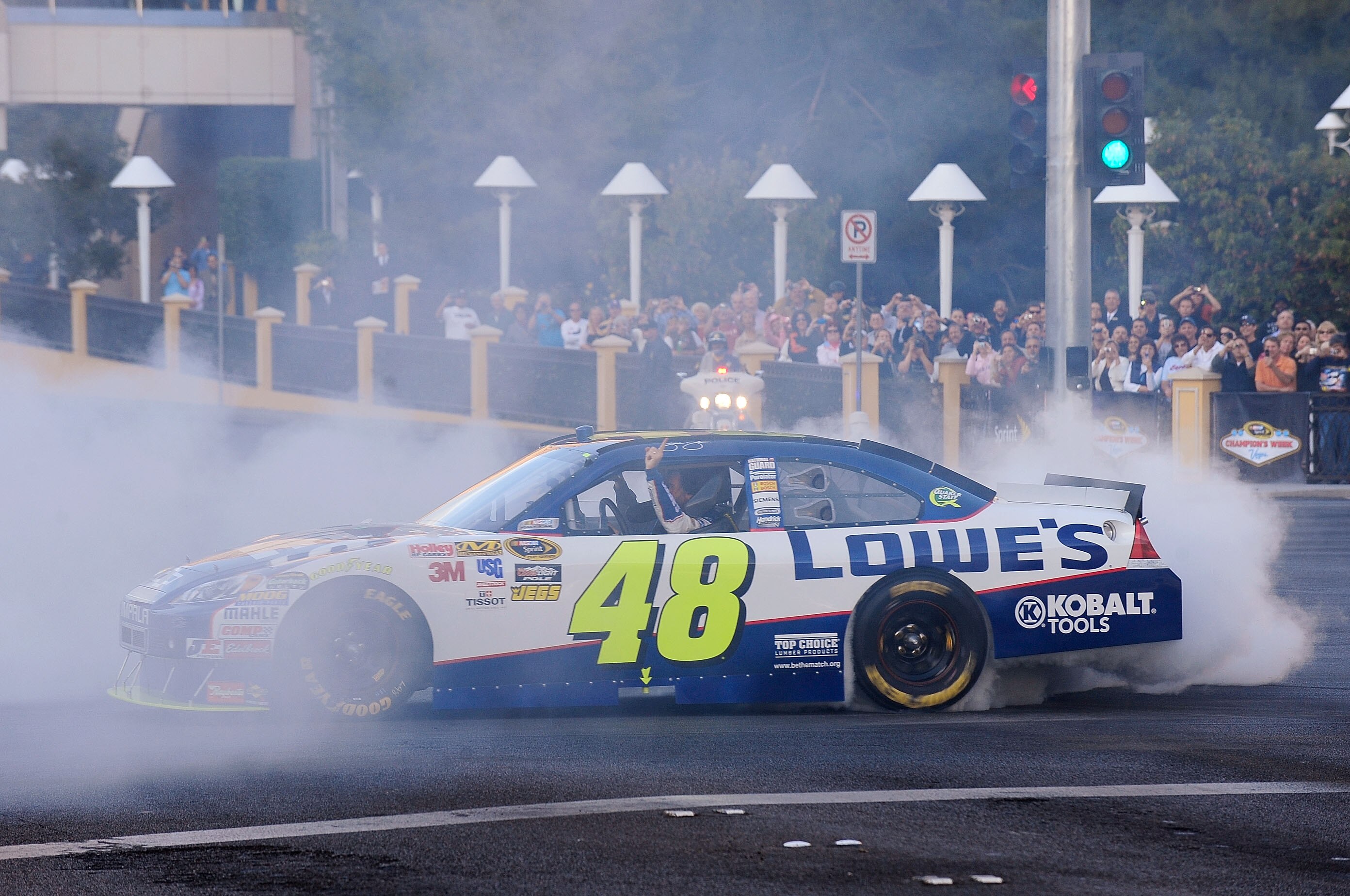 LAS VEGAS, NV - DECEMBER 02:  NASCAR driver Jimmie Johnson does a burnout during the NASCAR Victory Lap through the streets of Las Vegas on December 2, 2010 in Las Vegas, Nevada.  (Photo by Rusty Jarrett/Getty Images for NASCAR)