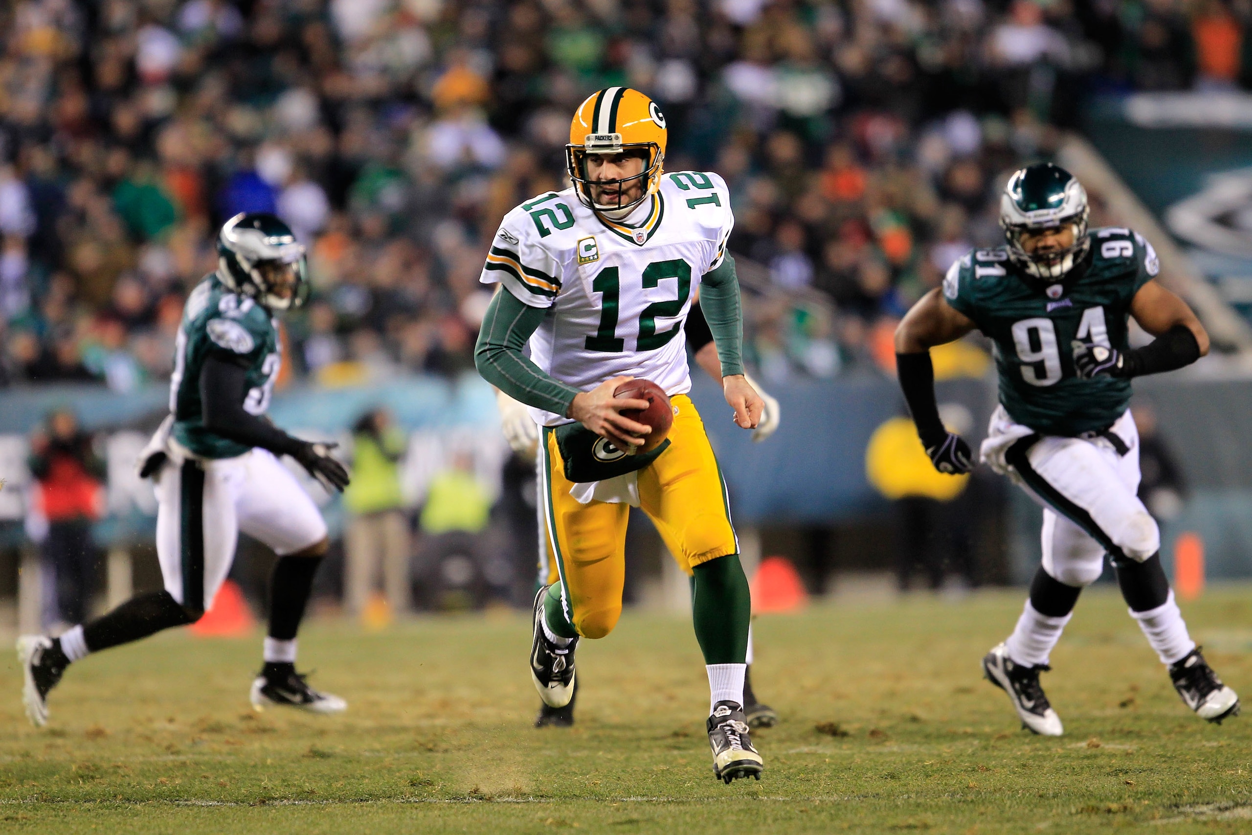 PHILADELPHIA, PA - JANUARY 09: Aaron Rodgers #12 of the Green Bay Packers carries the ball against the Philadelphia Eagles during the 2011 NFC wild card playoff game at Lincoln Financial Field on January 9, 2011 in Philadelphia, Pennsylvania. (Photo by PHILADELPHIA, PA - JANUARY 09: Aaron Rodgers #12 of the Green Bay Packers carries the ball against the Philadelphia Eagles during the 2011 NFC wild card playoff game at Lincoln Financial Field on January 9, 2011 in Philadelphia, Pennsylvania. (Photo by