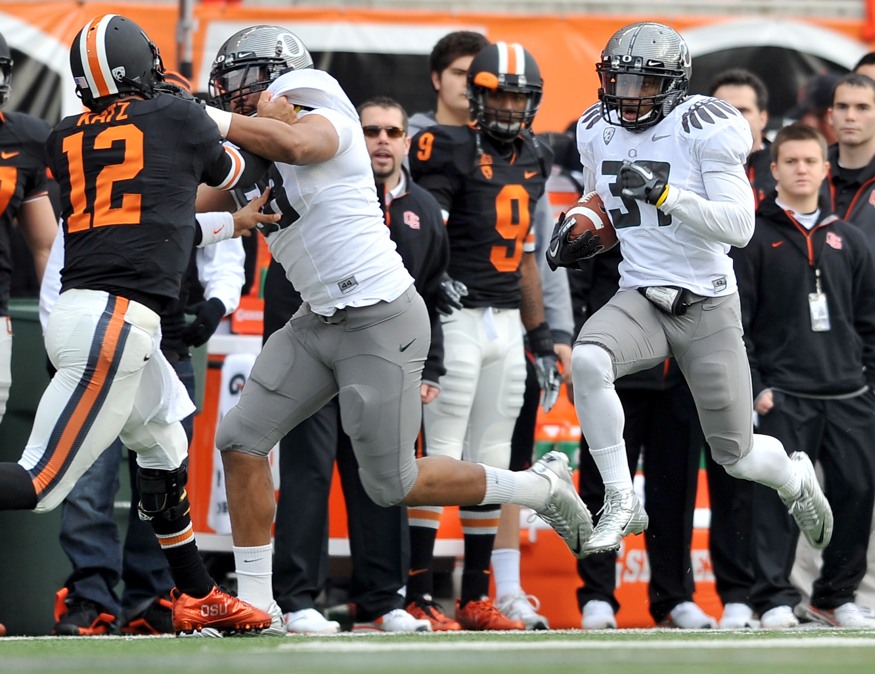 CORVALLIS, OR - DECEMBER 4: Talmadge Jackson III #37 of the Oregon Ducks runs back an interception as Kenny Rowe #58 of the Oregon Ducks blocks quarterback Ryan Katz #12 of the Oregon State Beavers in the second quarter the game at Reser Stadium on Decemb