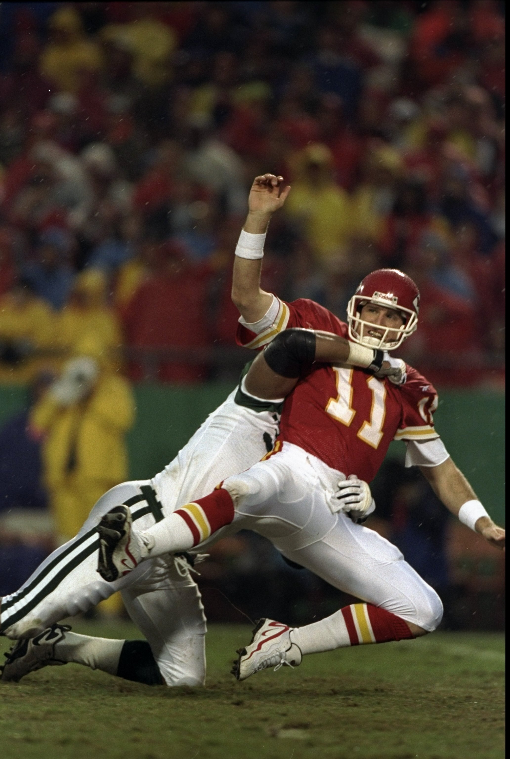 1 Nov 1998:  Quarterback Elvis Grbac #11 of the Kansas City Chiefs getting tackled by Anthony Pleasant during the game against the New York Jets at the Arrowhead Stadium in Kansas City, Missouri. The Jets defeated the Chiefs 20-17. Mandatory Credit: Jon F