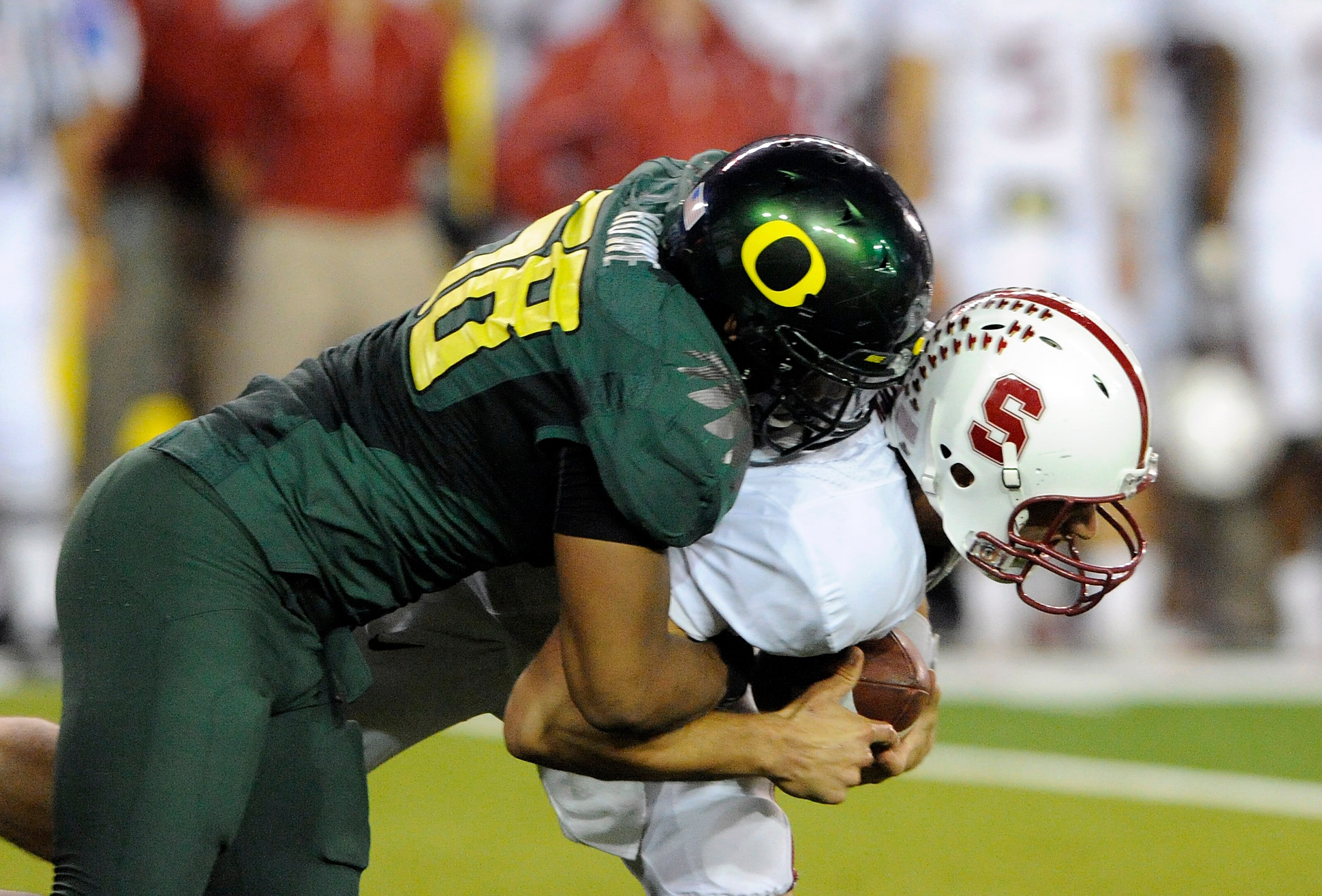 EUGENE, OR - OCTOBER 2: Quarterback Andrew Luck #12 of the Stanford Cardinal is sacked by defensive end Kenny Rowe #58 of the Oregon Ducks in the third quarter of the game at Autzen Stadium on October 2, 2010 in Eugene, Oregon. Oregon won the game 52-31.
