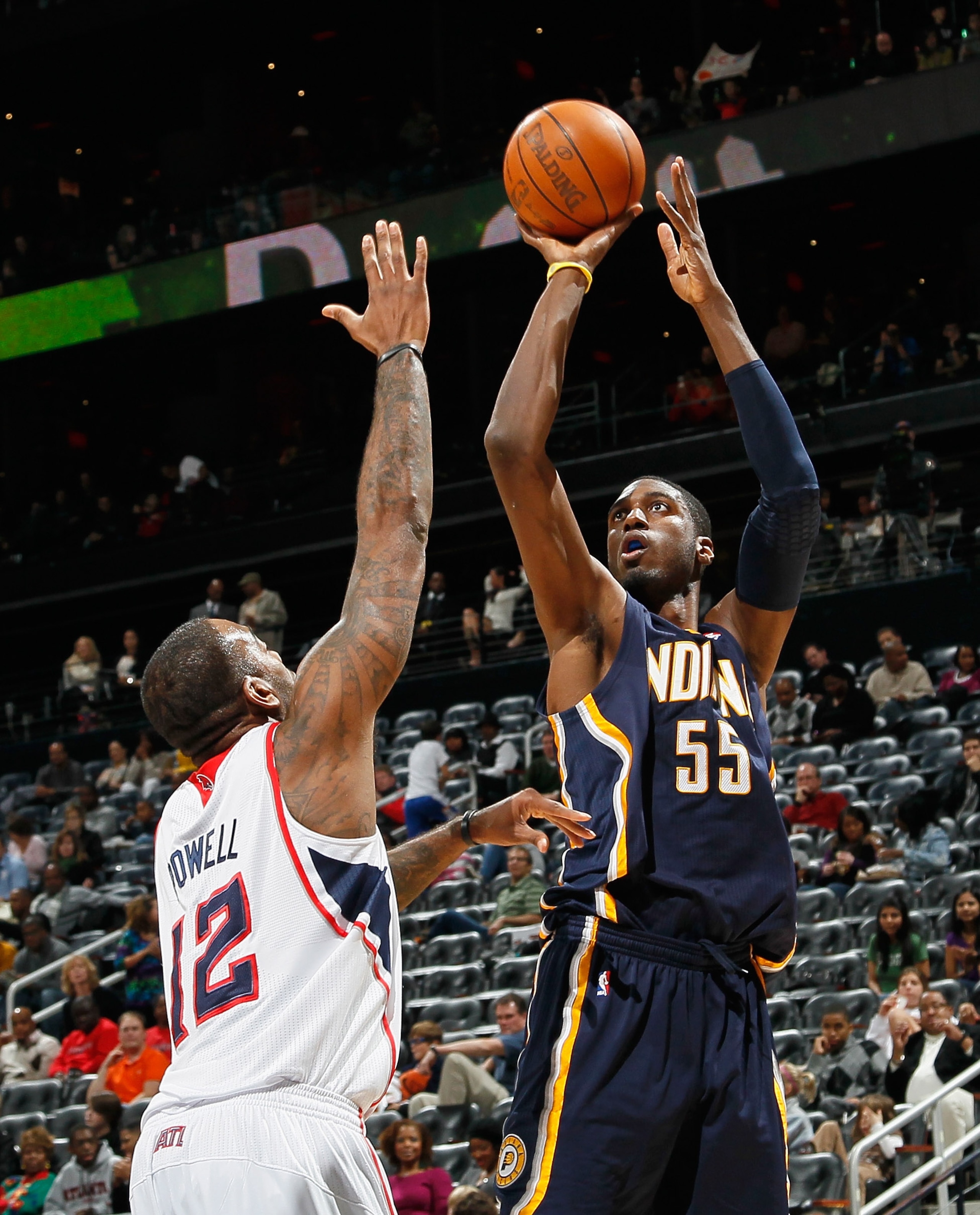 ATLANTA, GA - DECEMBER 11:  Roy Hibbert #55 of the Indiana Pacers against Josh Powell #12 of the Atlanta Hawks at Philips Arena on December 11, 2010 in Atlanta, Georgia.  NOTE TO USER: User expressly acknowledges and agrees that, by downloading and/or usi