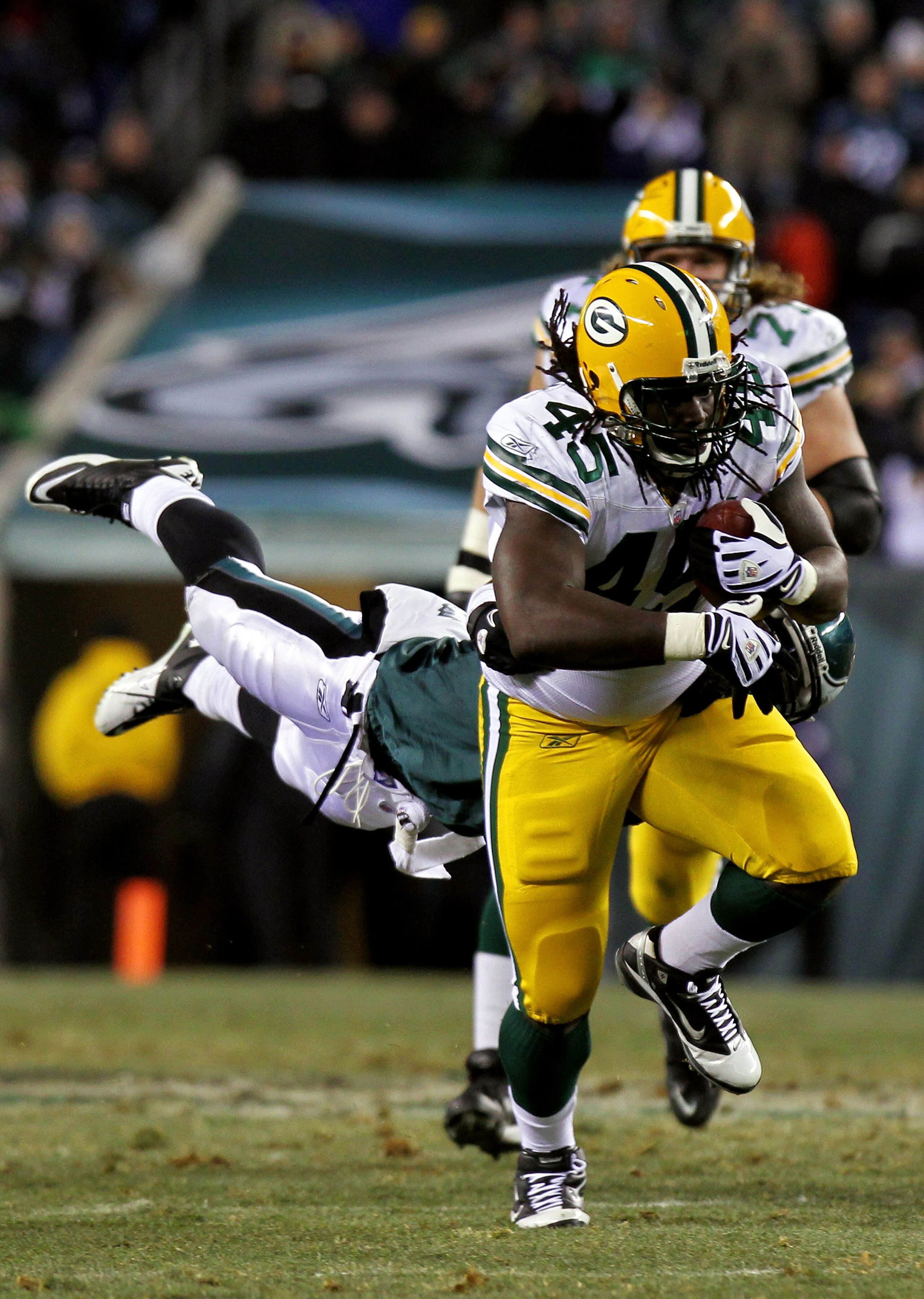PHILADELPHIA, PA - JANUARY 09:  James Starks #44 of the Green Bay Packers runs through the tackle of Ernie Sims #50 of the Philadelphia Eagles during the 2011 NFC wild card playoff game at Lincoln Financial Field on January 9, 2011 in Philadelphia, Pennsy