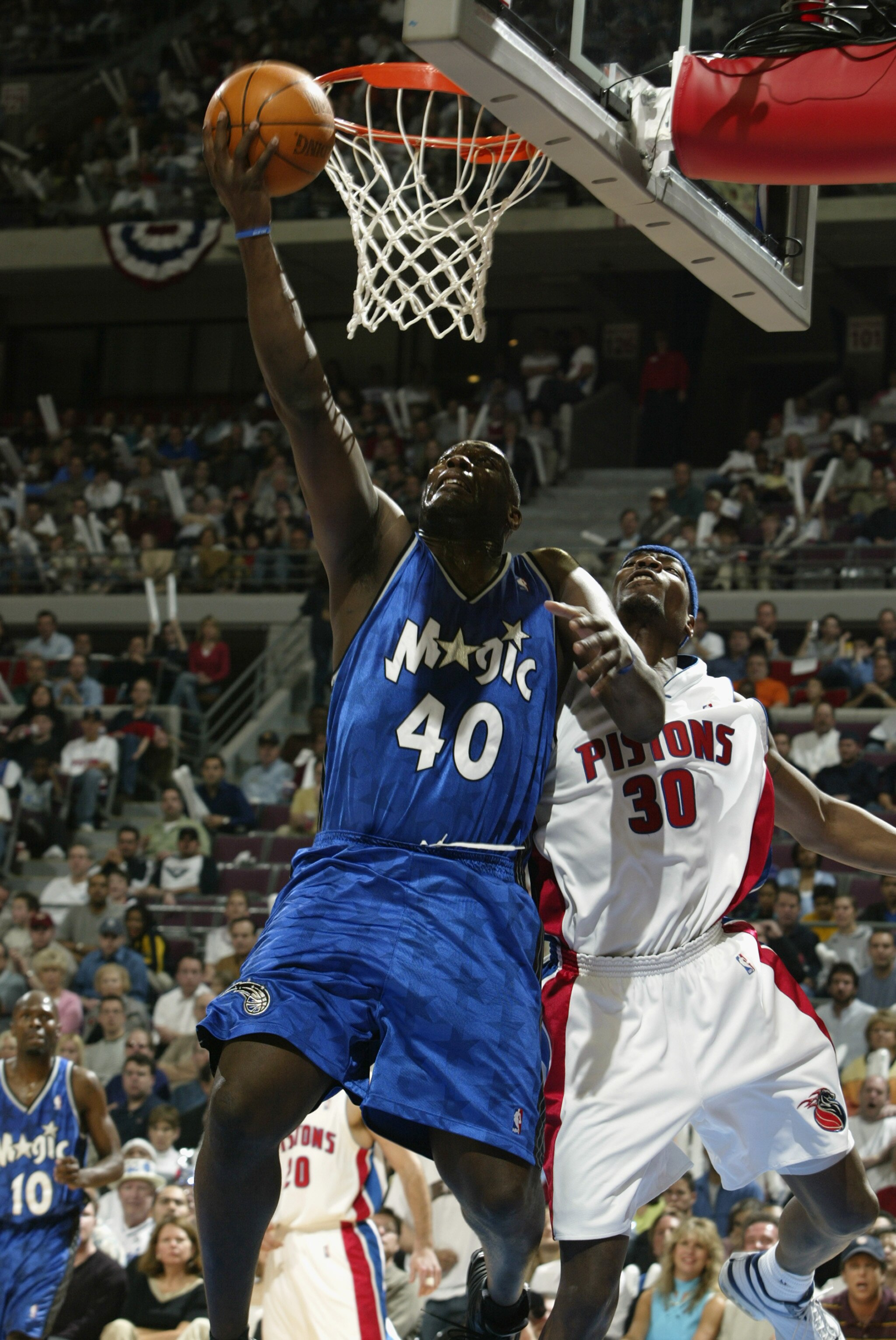 AUBURN HILLS, MI - APRIL 20:  Shawn Kemp #40 of the Orlando Magic shoots past Clifford Robinson #30 of the Detroit Pistons in Game one of the Eastern Conference Quarterfinals during the 2003 NBA Playoffs at The Palace of Auburn Hills on April 20, 2003 in