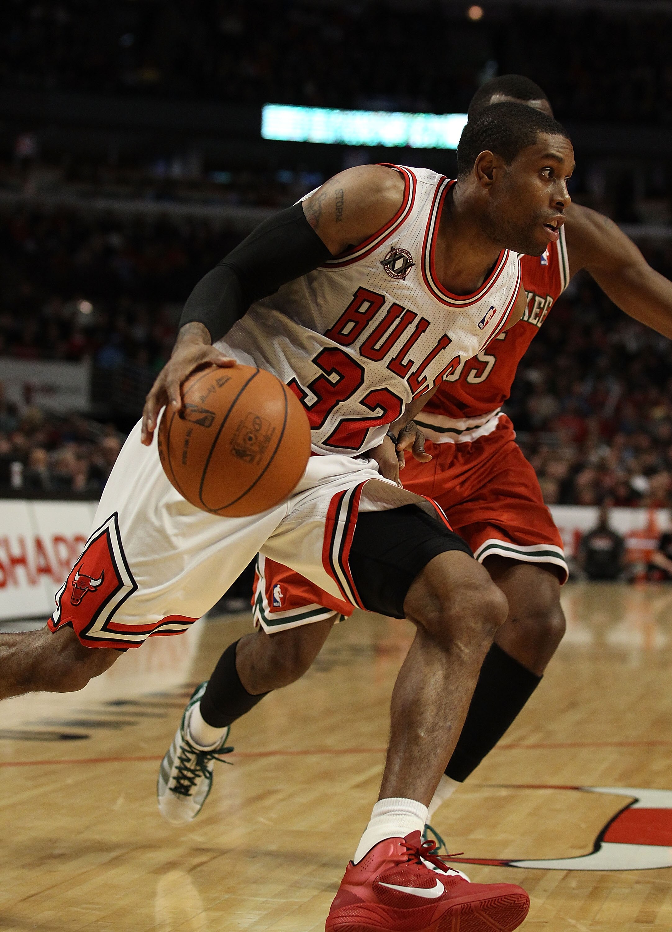 CHICAGO, IL - DECEMBER 28: C.J. Watson #32 of the Chicago Bulls drives against Keyon Dooling #55 of the Milwaukee Bucks at the United Center on December 28, 2010 in Chicago, Illinois. The Bulls defeated the Bucks 90-77. NOTE TO USER: User expressly acknow