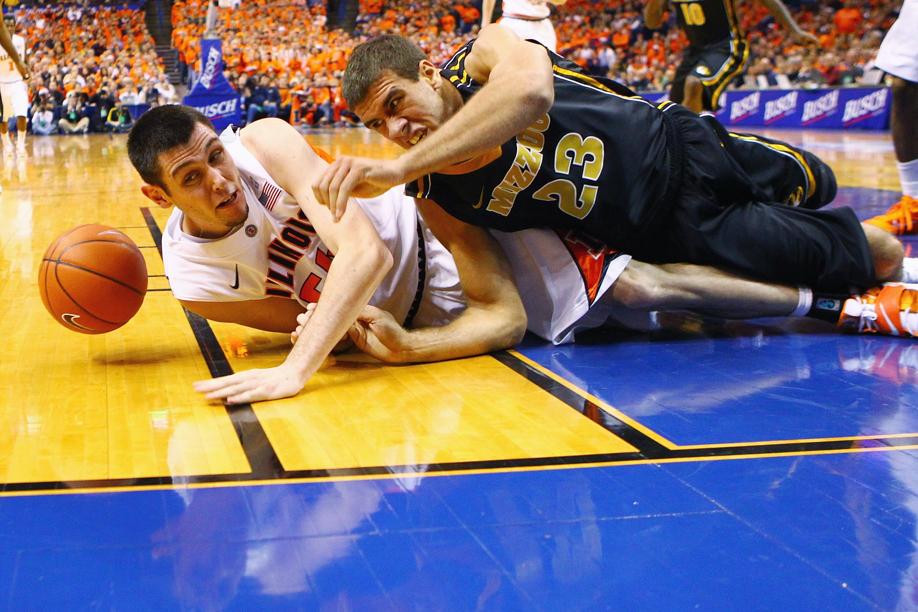ST. LOUIS, MO - DECEMBER 22: Mike Tisdale #54 of the Illinois Fighting Illini and Justin Safford #23 of the Missouri Tigers look to pick up a loose ball during the Busch Braggin' Rights game at the Scottrade Center on December 22, 2010 in St. Louis, Misso