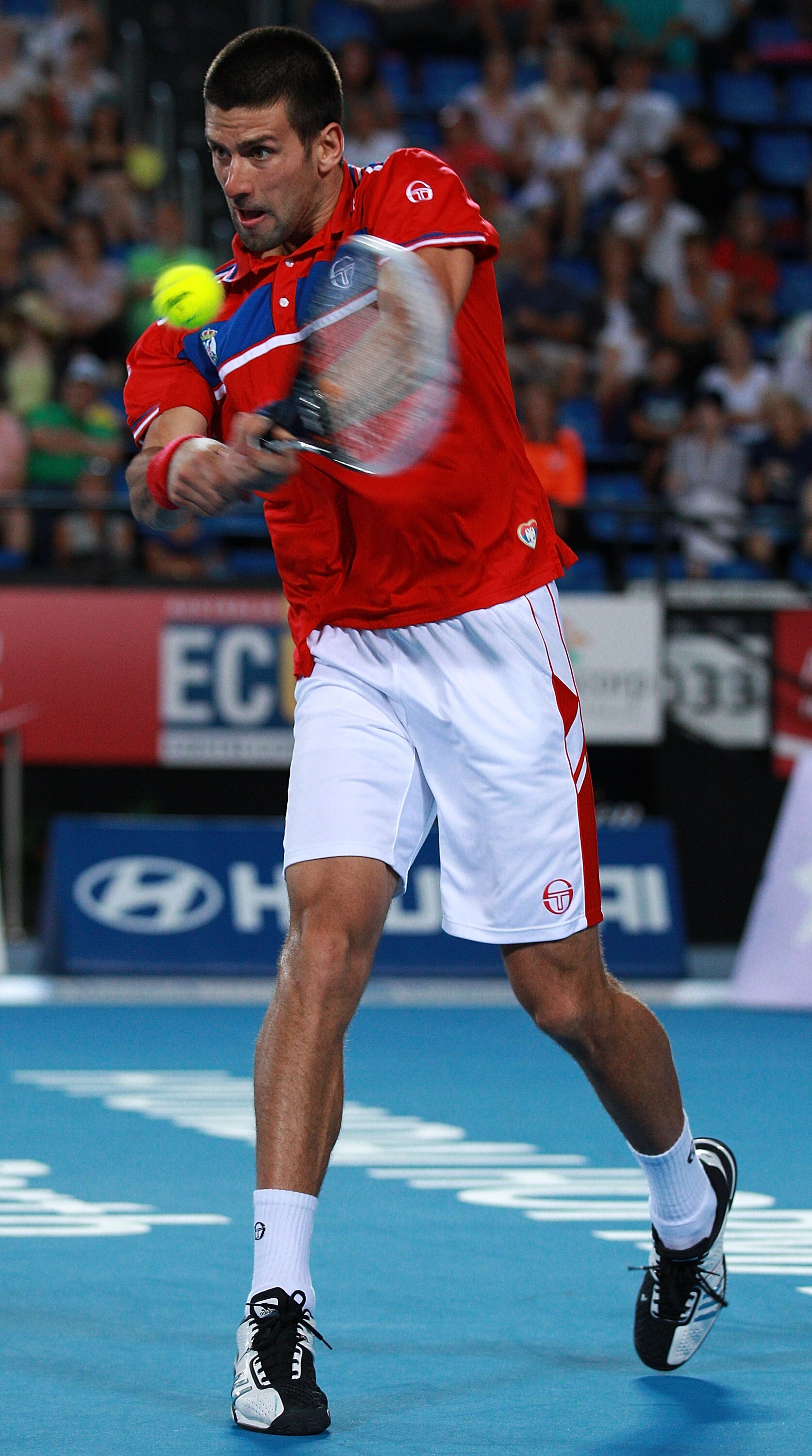 PERTH, AUSTRALIA - JANUARY 06:  Novak Djokovic of Serbia plays a return shot during his singles match against Ruben Bemelmans of Belgium on day six of the Hopman Cup at The Burswood Dome on January 6, 2011 in Perth, Australia.  (Photo by Paul Kane/Getty I