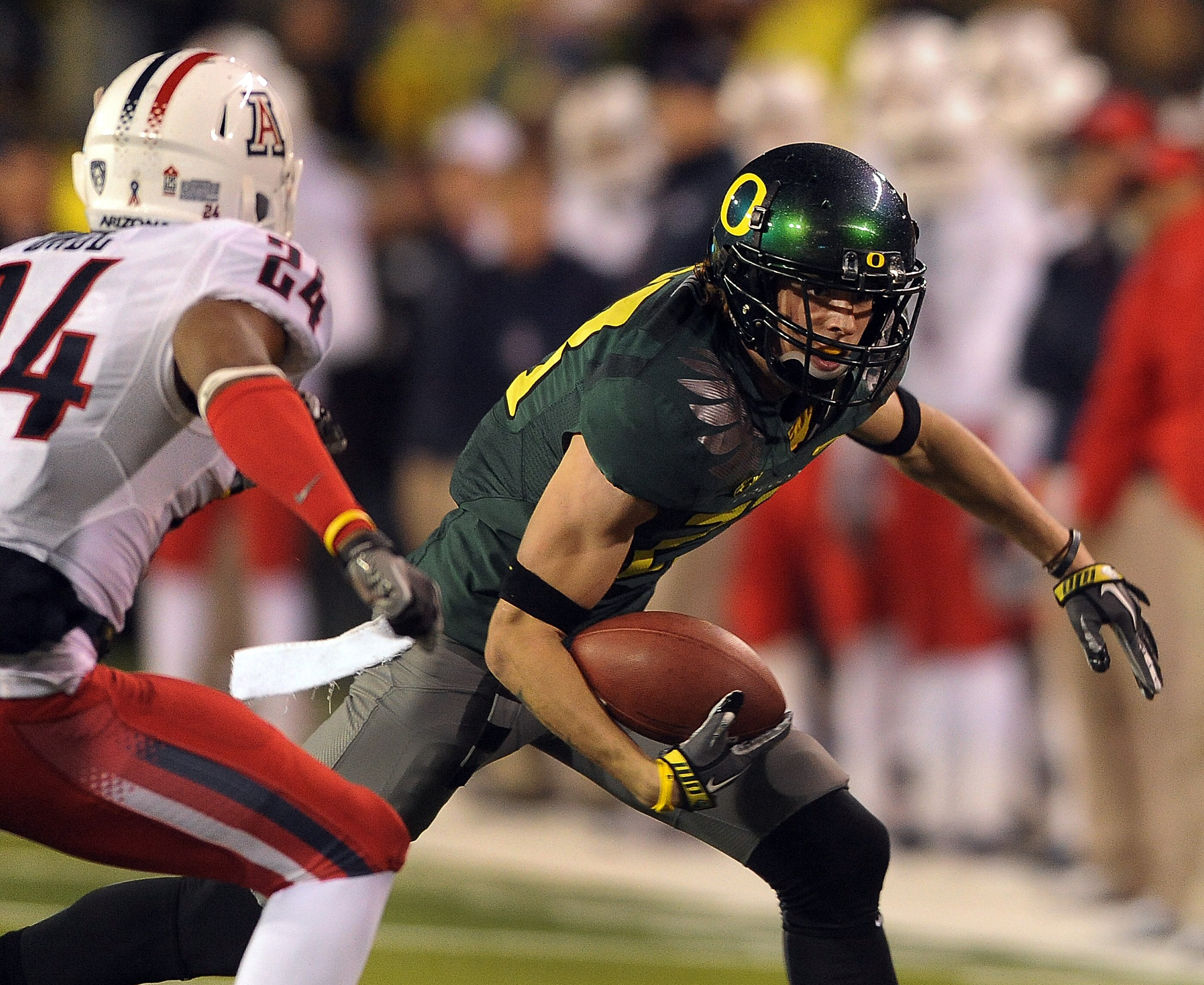 EUGENE, OR - NOVEMBER 26: Wide receiver Jeff Maehl #23 of the Oregon Ducks puts a move on cornerback Trevin Wade #24 of the Arizona Wildcats in the fourth quarter of the game at Autzen Stadium on November 26, 2010 in Eugene, Oregon. The Ducks won the game