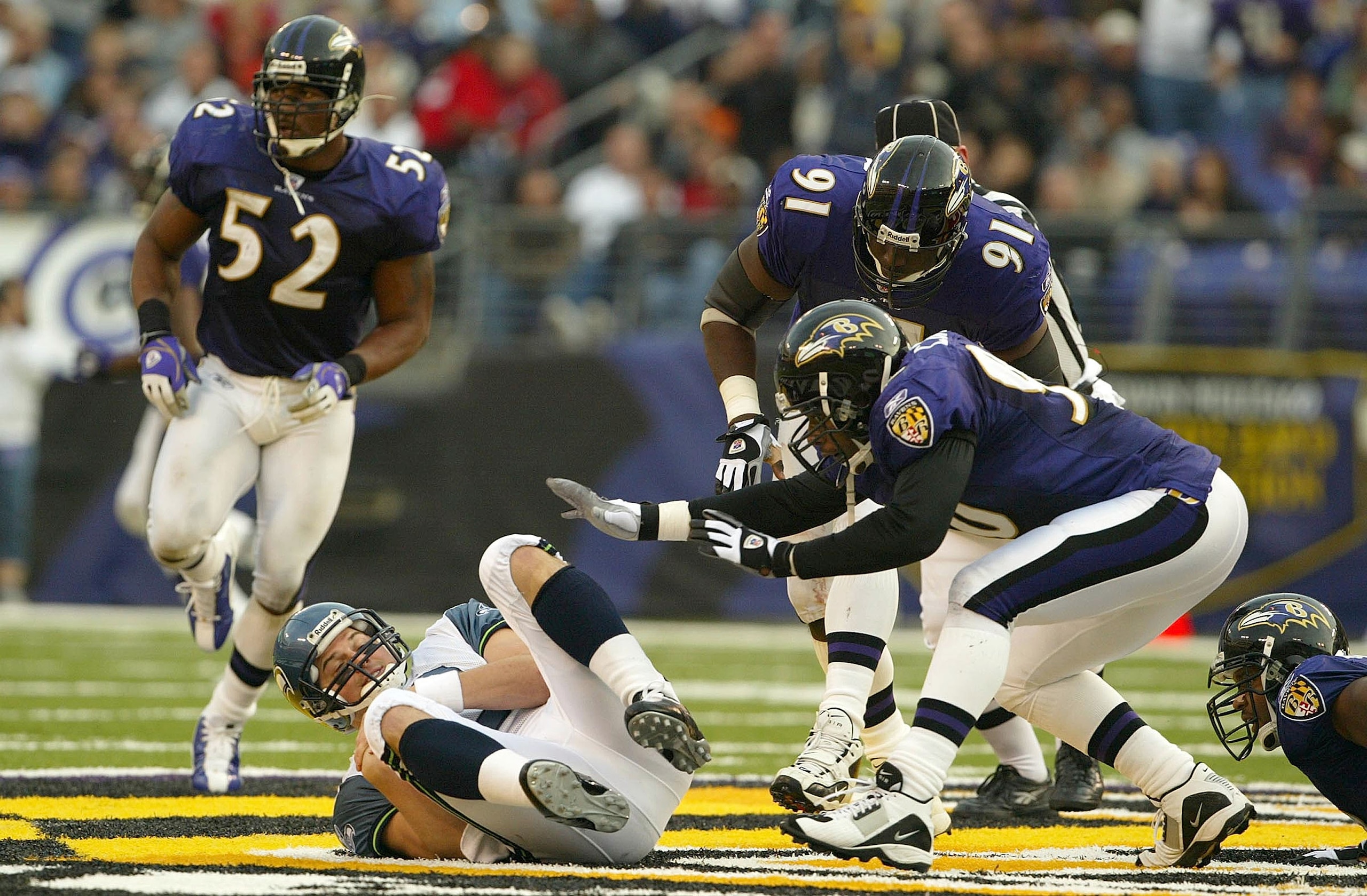 BALTIMORE - NOVEMBER 23:  Cornell Brown #90, Riddick Parker #91 and Ray Lewis #52 of the Baltimore Ravens close in on quarterback Matt Hasselbeck #8 of the Seattle Seahawks to record a sack as the Ravens defeated the Seahawks 44-41 on November 23, 2003 at