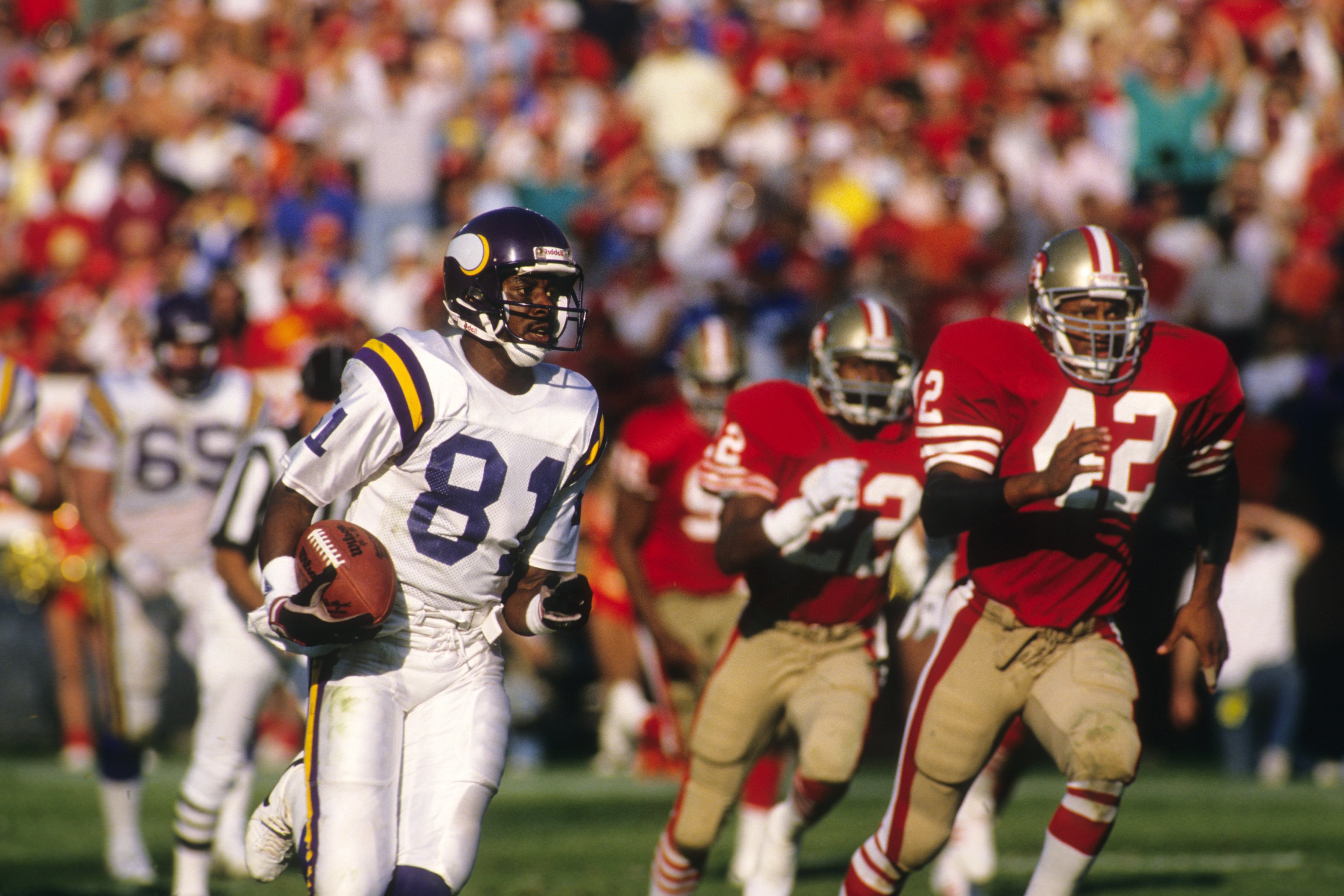 SAN FRANCISCO - OCTOBER 30:  Wide receiver Anthony Carter #81 of the Minnesota Vikings runs away from Ronnie Lott #42 of the San Francisco 49ers during a game at Candlestick Park on October 30, 1988 in San Francisco, California.  The 49er won 24-21.  (Pho