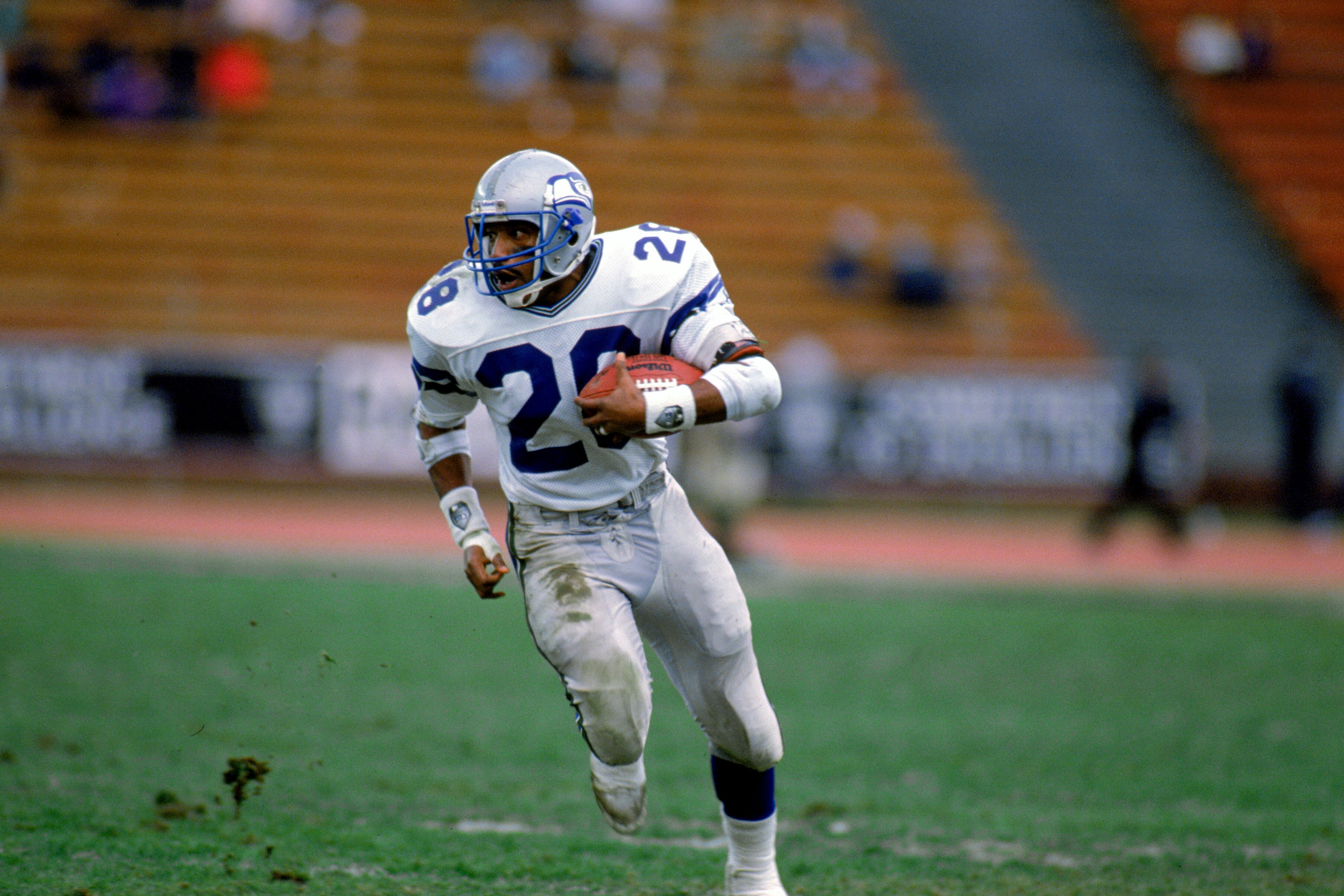 LOS ANGELES - DECEMBER 18:  Running back Curt Warner #28 of the Seattle Seahawks runs the football against the Los Angeles Raiders at the Los Angeles Coliseum on December 18, 1988 in Los Angeles, California. The Seahawks defeated the Raiders 43-37.  (Phot