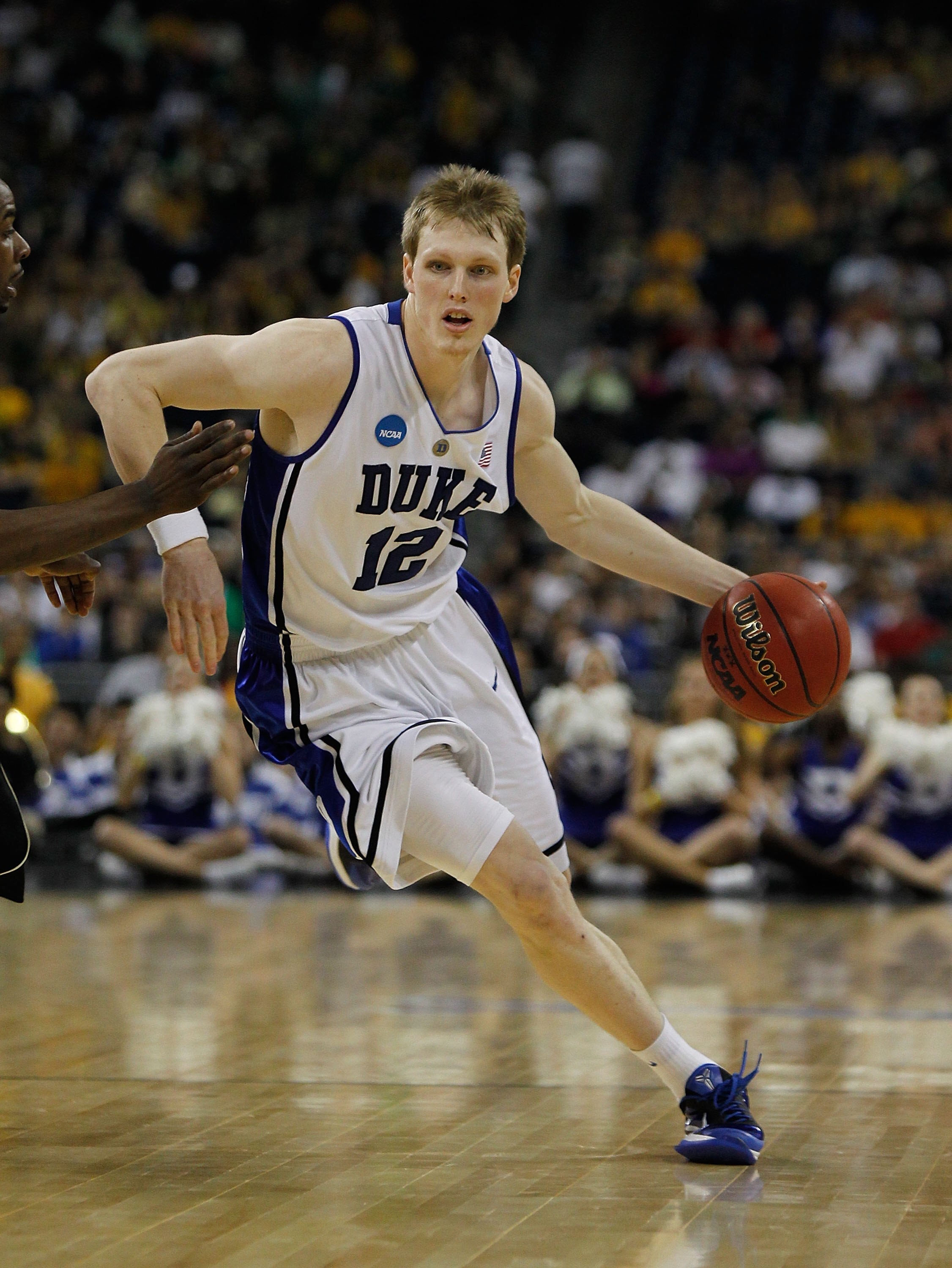 HOUSTON - MARCH 26: Kyle Singler #12 of the Duke Blue Devils moves with the ball against the Purdue Boilermakers during the south regional semifinal of the 2010 NCAA men's basketball tournament at Reliant Stadium on March 26, 2010 in Houston, Texas. Duke 