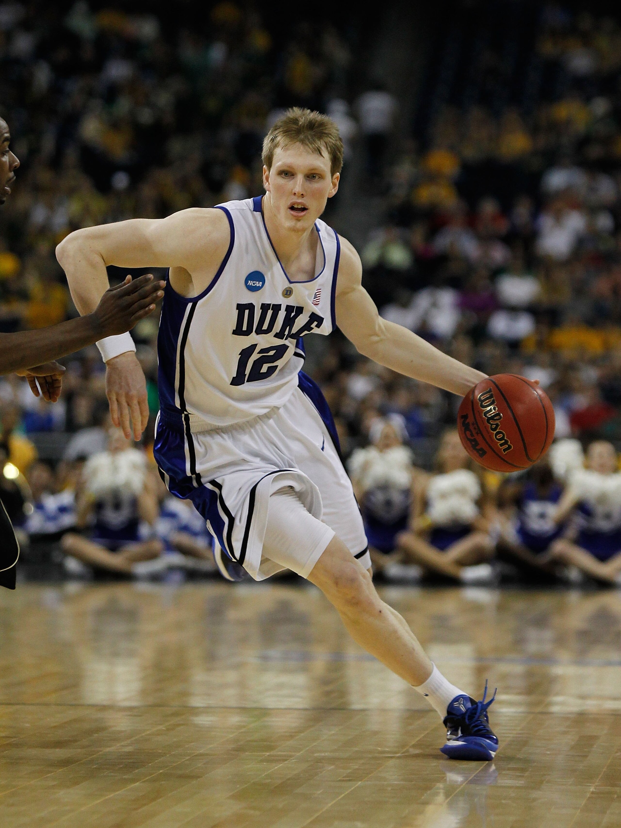 HOUSTON - MARCH 26: Kyle Singler #12 of the Duke Blue Devils moves with the ball against the Purdue Boilermakers during the south regional semifinal of the 2010 NCAA men's basketball tournament at Reliant Stadium on March 26, 2010 in Houston, Texas. Duke HOUSTON - MARCH 26: Kyle Singler #12 of the Duke Blue Devils moves with the ball against the Purdue Boilermakers during the south regional semifinal of the 2010 NCAA men's basketball tournament at Reliant Stadium on March 26, 2010 in Houston, Texas. Duke