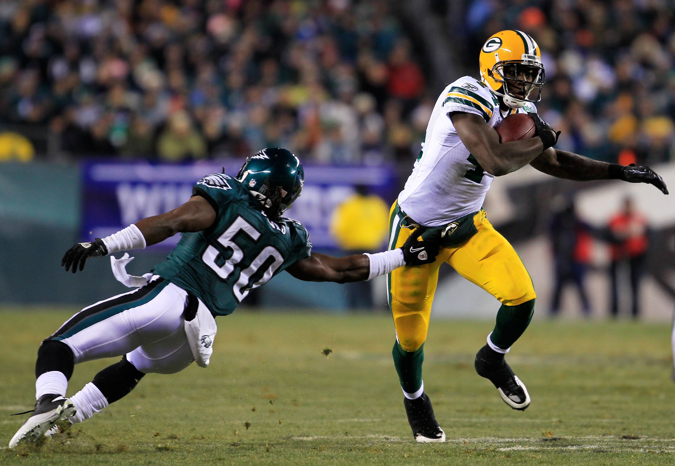 PHILADELPHIA, PA - JANUARY 09:  James Starks #44 of the Green Bay Packers avoids the tackle of Ernie Sims #50 of the Philadelphia Eagles during the 2011 NFC wild card playoff game at Lincoln Financial Field on January 9, 2011 in Philadelphia, Pennsylvania