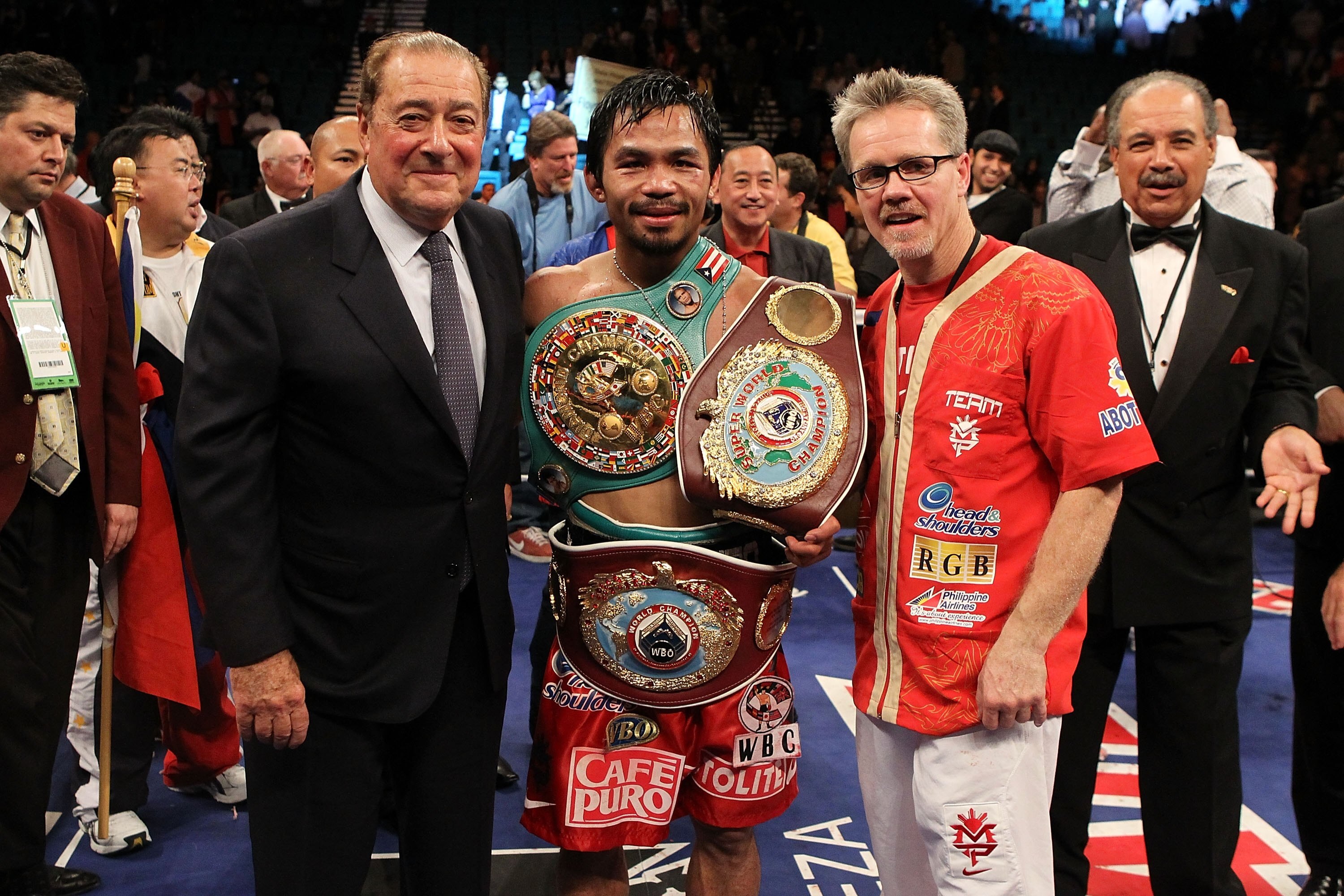 LAS VEGAS - NOVEMBER 14:  (L-R) Promoter Bob Arum, boxer Manny Pacquiao and trainer Freddie Roach celebrate Pacquiao's 12 round TKO victory against Miguel Cotto during their WBO welterweight title fight at the MGM Grand Garden Arena on November 14, 2009 i