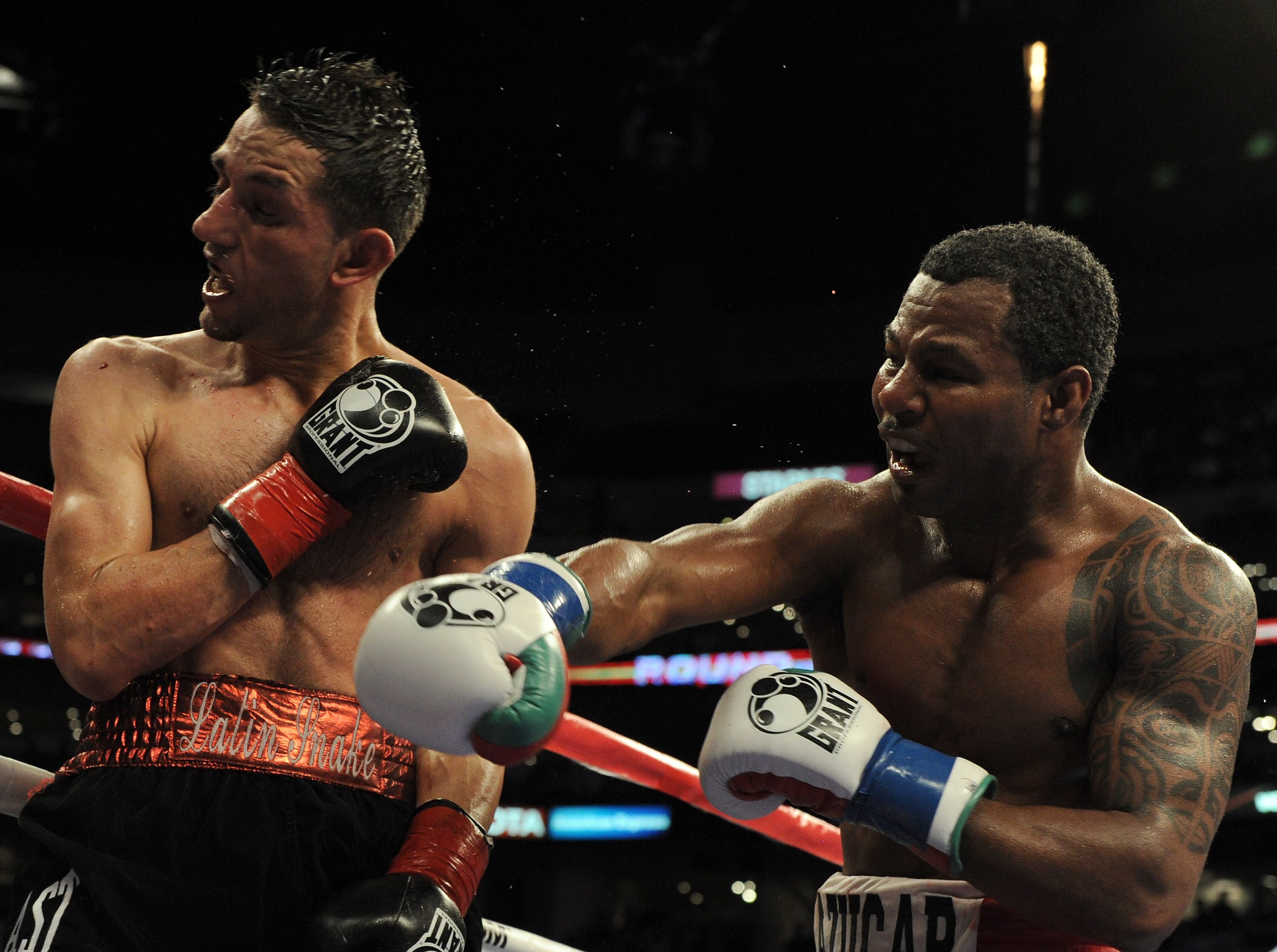 LOS ANGELES, CA - SEPTEMBER 18:  Sergio Mora takes a punch from Shane Mosley during the 10th round of the Middleweight bout at Staples Center on September 18, 2010 in Los Angeles, California.  The fight ended in a draw.  (Photo by Harry How/Getty Images)