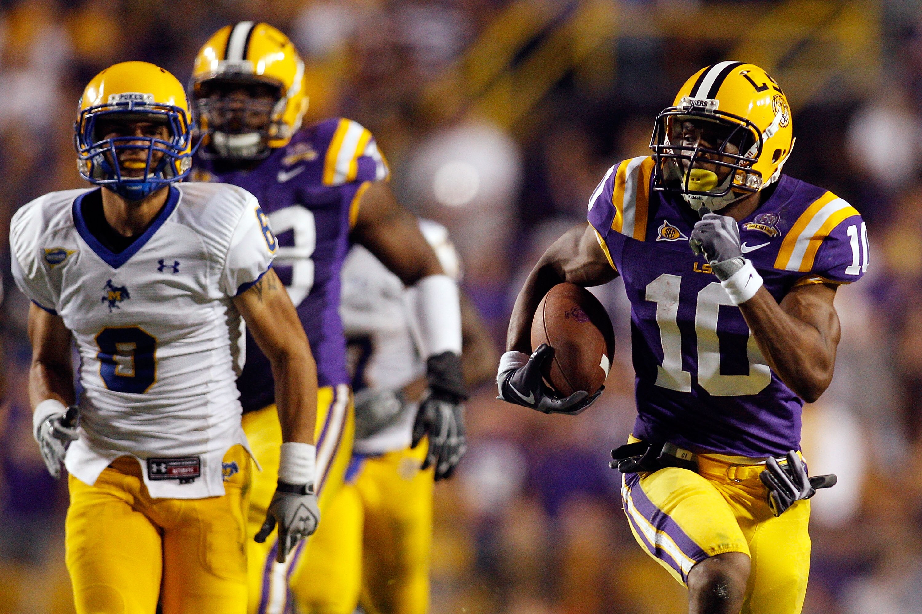 BATON ROUGE, LA - OCTOBER 16:  Russell Shepard #10 of the Louisiana State University Tigers runs past Jace Peterson #6 of the McNeese State Cowboys at Tiger Stadium on October 16, 2010 in Baton Rouge, Louisiana.  The Tigers defeated the Cowboys 32-10.  (P