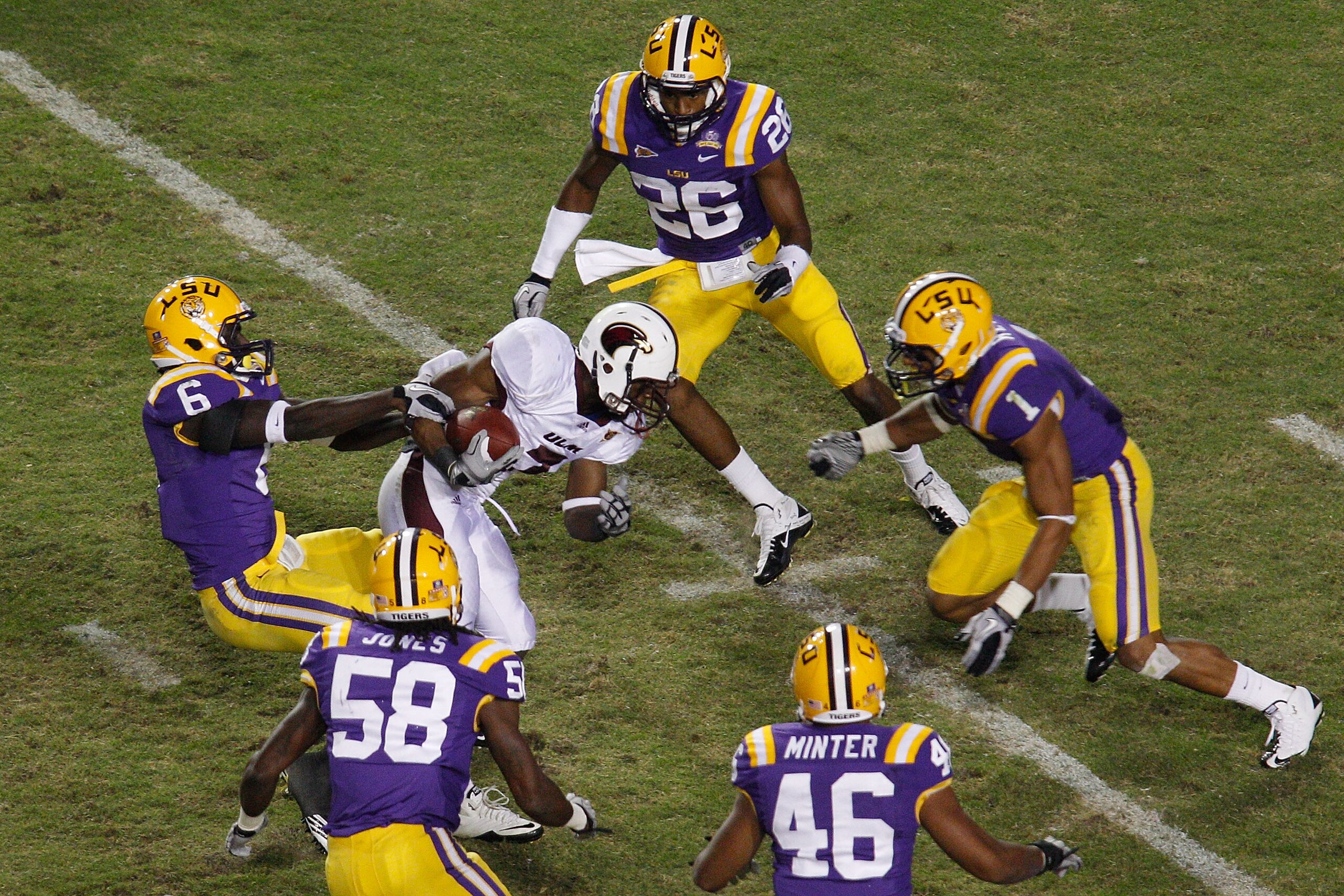 BATON ROUGE, LA - NOVEMBER 13: Jyruss Edwards #7 of the University of Louisiana-Monroe Warhawks avoids is tackled by Craig Loston #6 of the Louisiana State University Tigers at Tiger Stadium on November 13, 2010 in Baton Rouge, Louisiana. The Tigers def BATON ROUGE, LA - NOVEMBER 13: Jyruss Edwards #7 of the University of Louisiana-Monroe Warhawks avoids is tackled by Craig Loston #6 of the Louisiana State University Tigers at Tiger Stadium on November 13, 2010 in Baton Rouge, Louisiana. The Tigers def