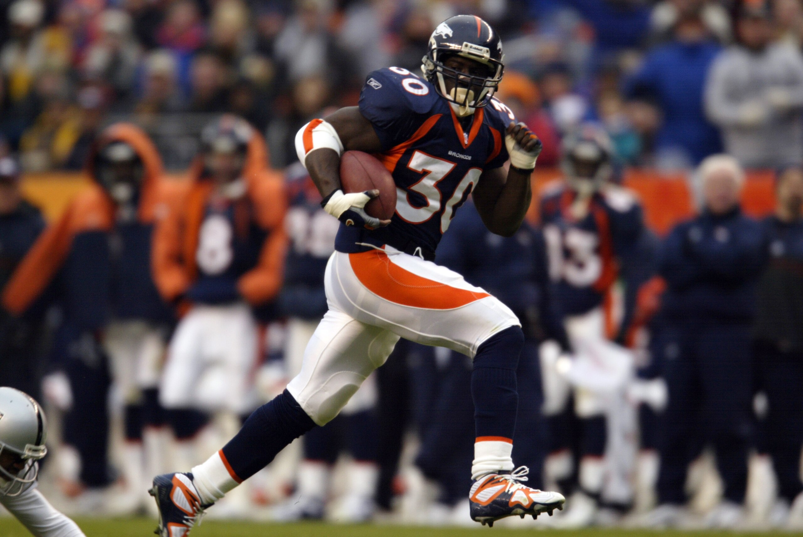 30 Dec 2001: Terrell Davis of the Denver Broncos gains yardage against the Oakland Raiders during the game at Invesco Field at Mile High Stadium in Denver, Colorado. The Broncos won 23-17. DIGITAL IMAGE. Mandatory Credit: Brian Bahr/Getty Images