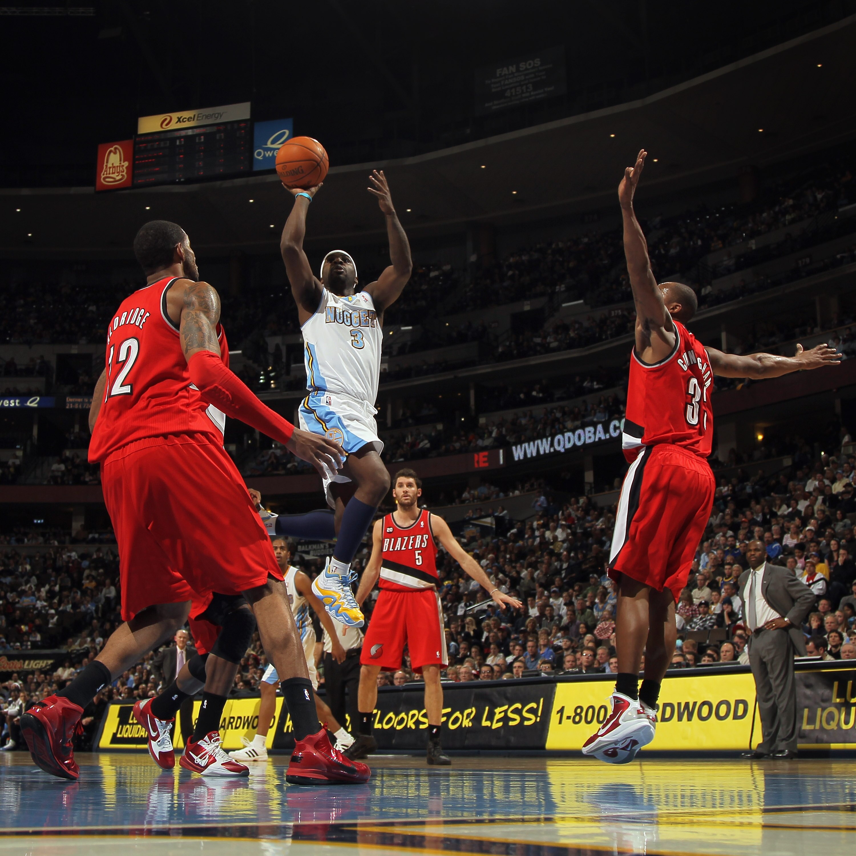 DENVER - DECEMBER 28:  Ty Lawson #3 of the Denver Nuggets takes a shot between Wesley Matthews #2 and Dante Cunningham #33 of the Portland Trail Blazers at Pepsi Center on December 28, 2010 in Denver, Colorado. The Nuggets defeated the Blazers 95-77. NOTE