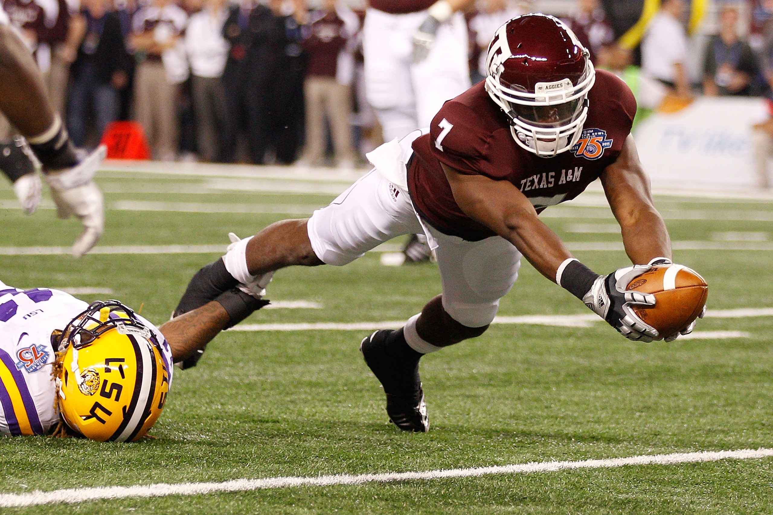 ARLINGTON, TX - JANUARY 07:  Uzoma Nwachukwu #7 of the Texas A&M Aggies scores a touchdown over Kelvin Sheppard #11 of the Louisiana State University Tigers during the AT&T Cotton Bowl at Cowboys Stadium on January 7, 2011 in Arlington, Texas.  (Photo by