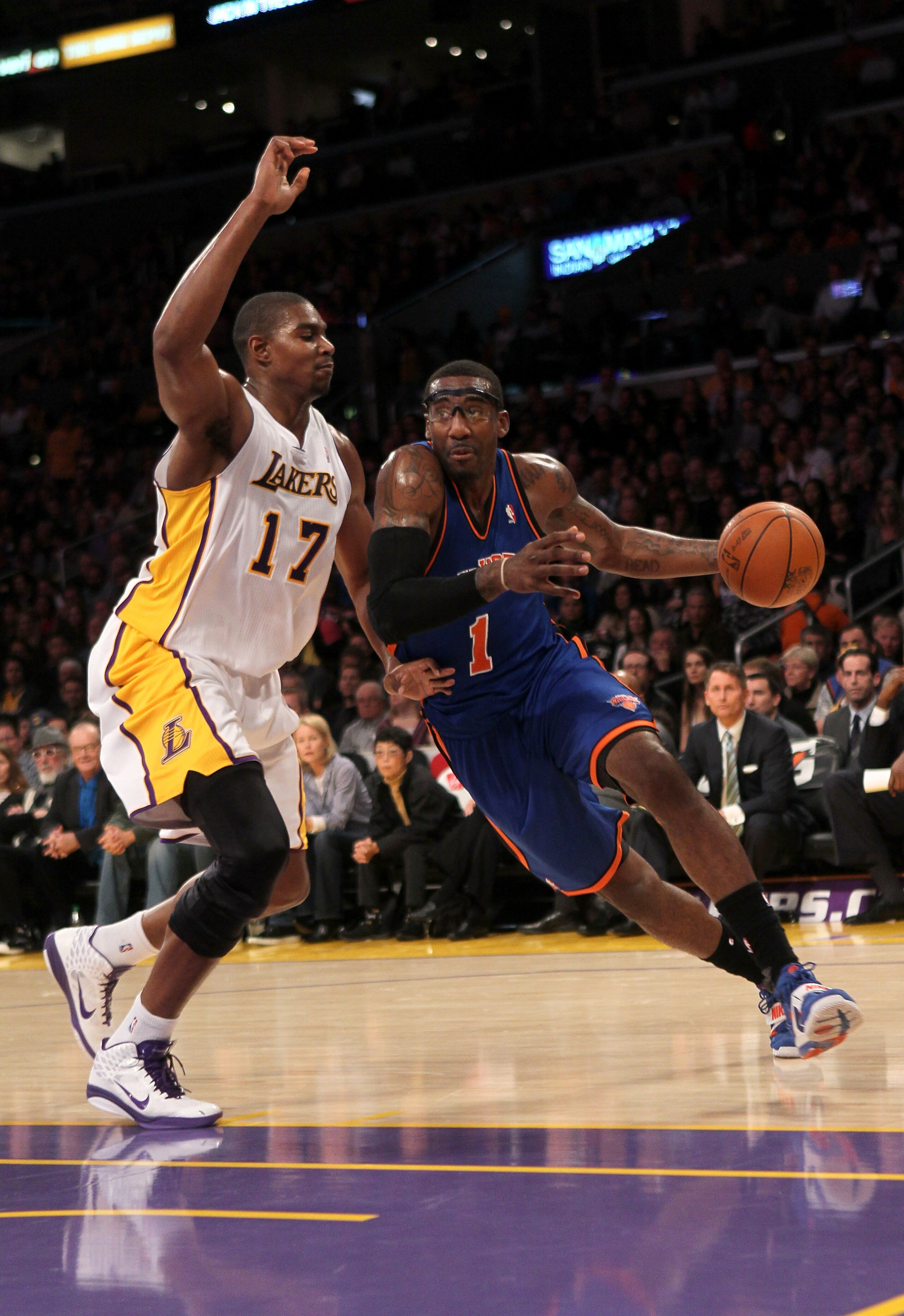 LOS ANGELES, CA - JANUARY 09: Amar'e Stoudemire #1 of the New York Knicks drives around Andrew Bynum #17 of the Los Angeles Lakers at Staples Center on January 9, 2011 in Los Angeles, California. The Lakers won 109-87. NOTE TO USER: User expressly ack LOS ANGELES, CA - JANUARY 09: Amar'e Stoudemire #1 of the New York Knicks drives around Andrew Bynum #17 of the Los Angeles Lakers at Staples Center on January 9, 2011 in Los Angeles, California. The Lakers won 109-87. NOTE TO USER: User expressly ack