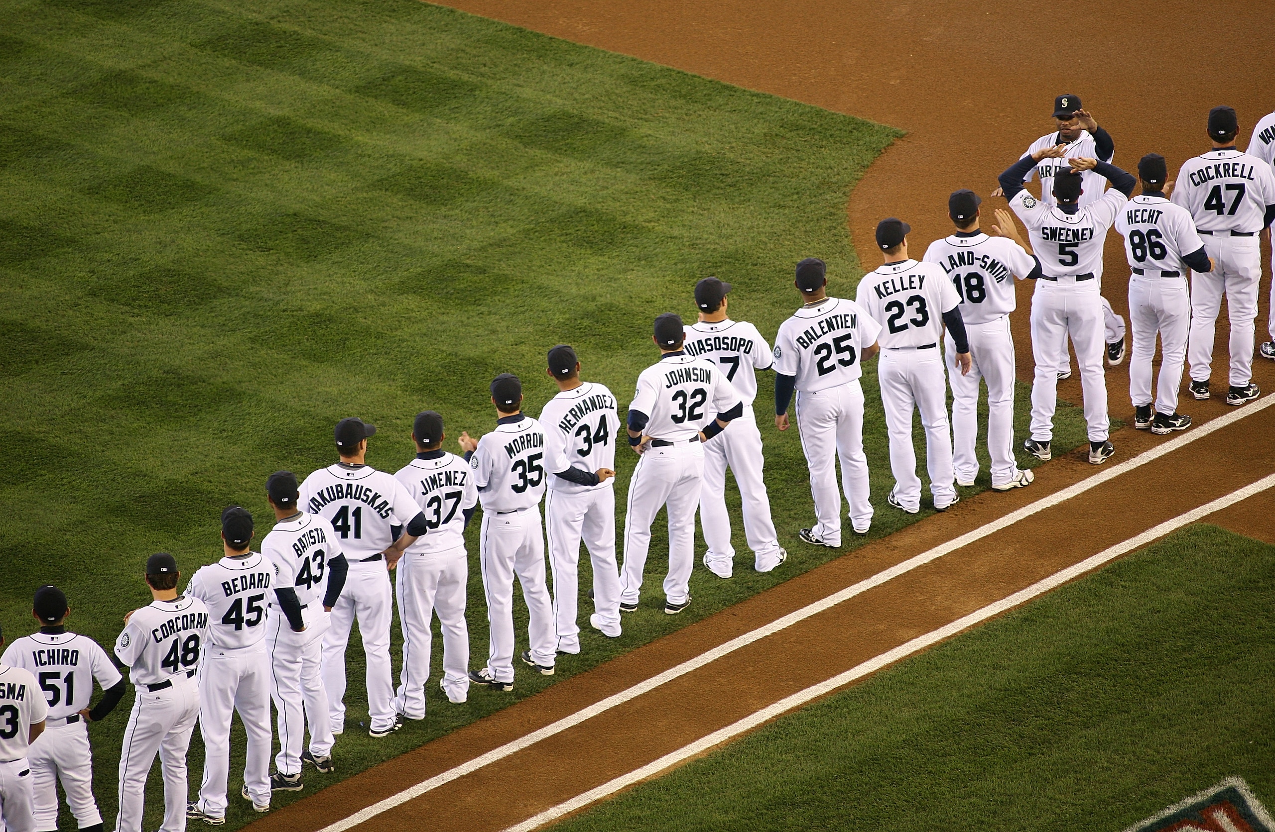 SEATTLE - APRIL 14:  Ken Griffey Jr. #24 of the Seattle Mariners is greeted by Mike Sweeney #5 during pregame ceremonies on the Opening Day game against the Los Angeles Angels of Anaheim on April 14, 2009 at Safeco Field in Seattle, Washington. (Photo by 