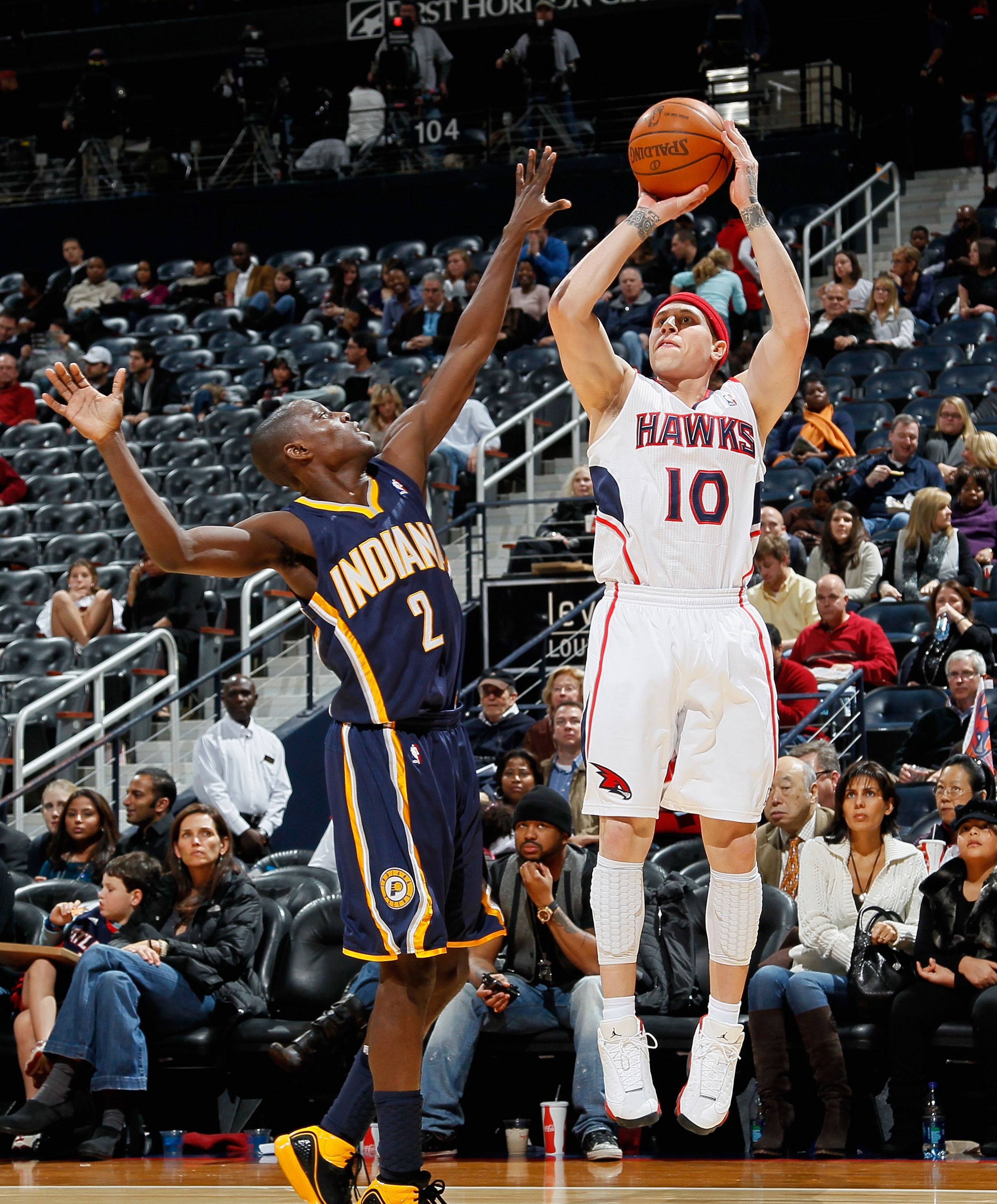 ATLANTA, GA - DECEMBER 11:  Mike Bibby #10 of the Atlanta Hawks against Darren Collison #2 of the Indiana Pacers at Philips Arena on December 11, 2010 in Atlanta, Georgia.  NOTE TO USER: User expressly acknowledges and agrees that, by downloading and/or u