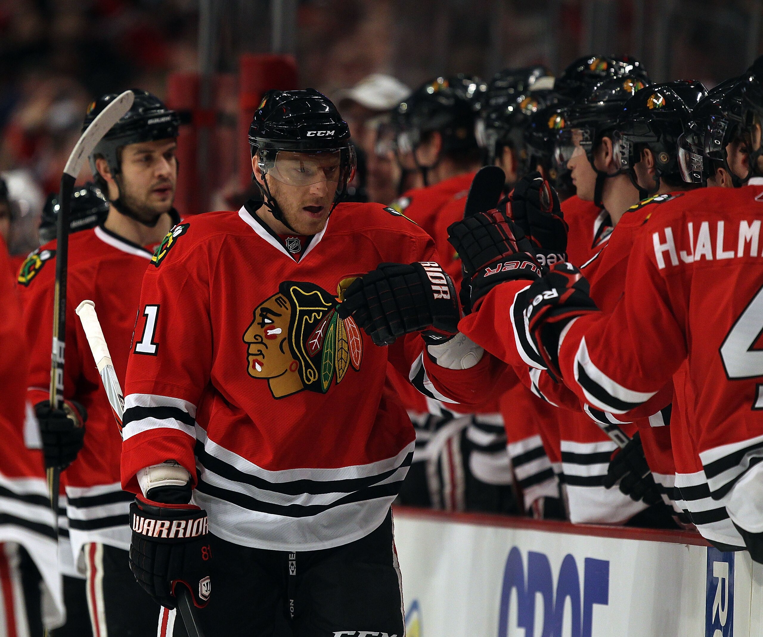 CHICAGO, IL - JANUARY 09: Marian Hossa #81 of the Chicago Blackhawks is congratulated by teammates after a goal was scored by Patrick Sharp against the New York Islanders at the United Center on January 9, 2011 in Chicago, Illinois. The Blackhawks defeate