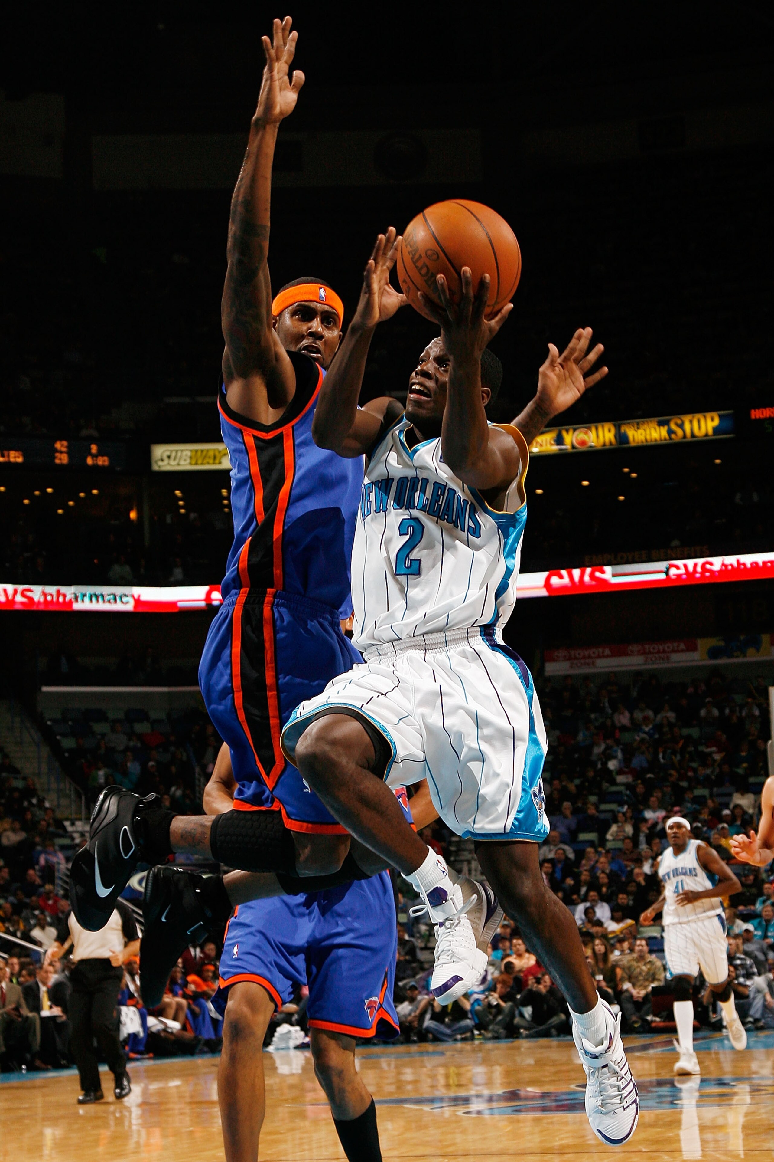 NEW ORLEANS - DECEMBER 11:  Darren Collison #2 of the New Orleans Hornets makes a shot over Eddy Curry #34 of the New York Nicks at New Orleans Arena on December 11, 2009 in New Orleans, Louisiana. NOTE TO USER: User expressly acknowledges and agrees that