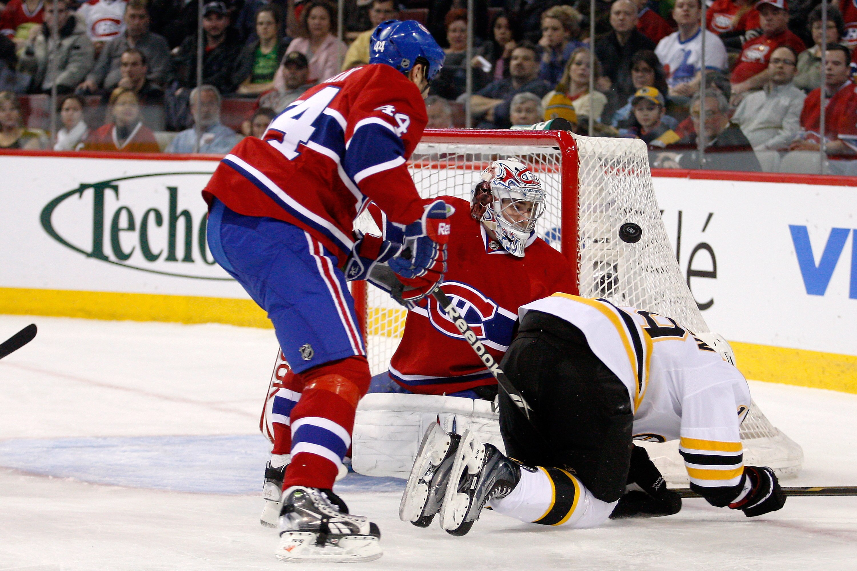 MONTREAL, CANADA - JANUARY 8:  Carey Price #31 of the Montreal Canadiens watches the rebounding puck in front of team mate Roman Hamrlik #44 and Tyler Seguin #19 of the Boston Bruins during the NHL game at the Bell Centre on January 8, 2011 in Montreal, Q