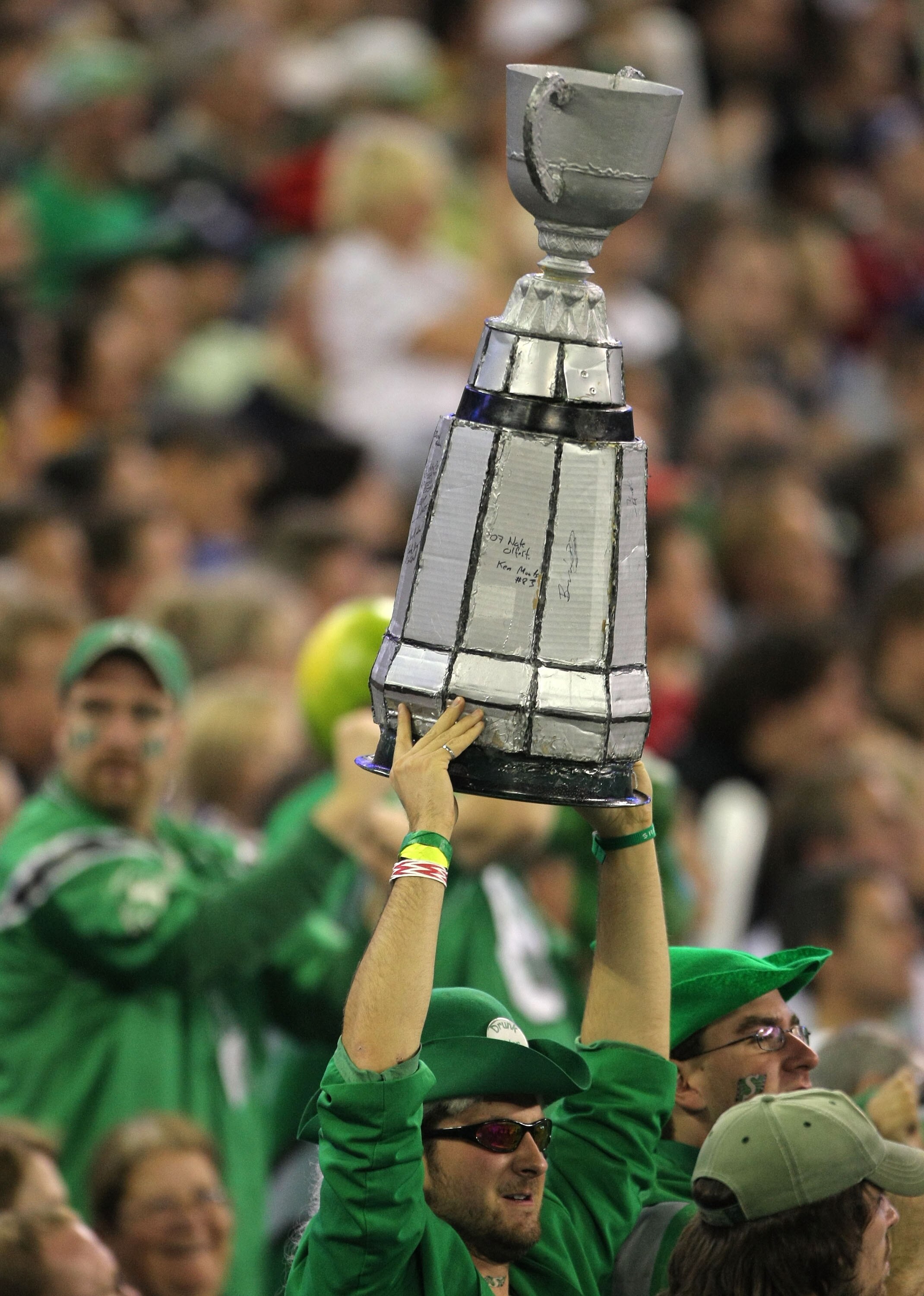 TORONTO, ON - NOVEMBER 25:  A Saskatchewan Rough Riders fan holds up a replica of the Grey Cup in a victory over the Winnipeg Blue Bombers during the 95th Grey Cup on November 25, 2007 at the Rogers Centre in Toronto, Ontario, Canada.  (Photo by Harry How