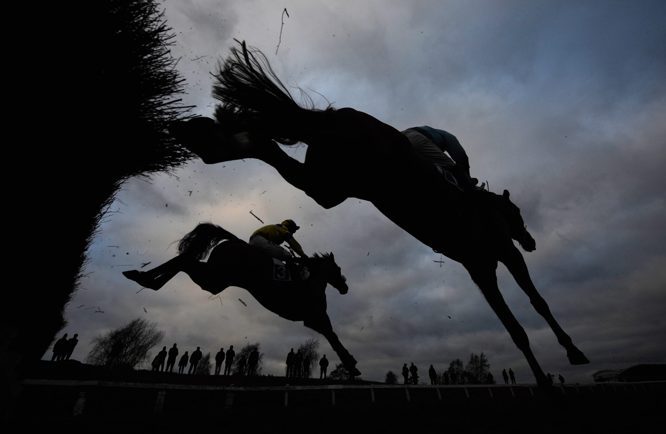 LEICESTER, ENGLAND - JANUARY 11: Runners jump a fence in the Leicester Annual Members Novices´ Chase at Leicester Racecourse on January 11, 2011 in Leicester, England.  (Photo by Michael Regan/Getty Images)
