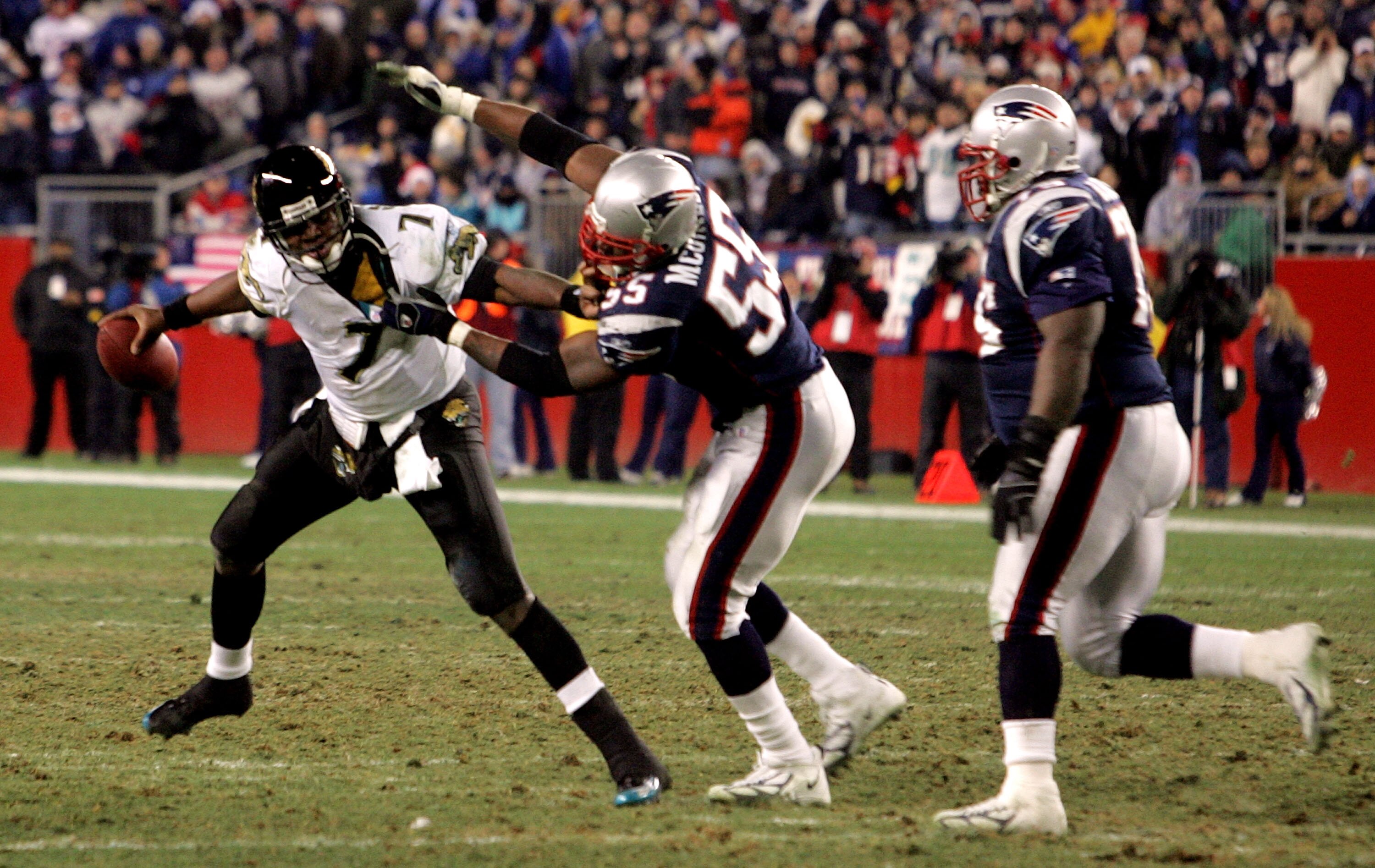 FOXBORO, MA - JANUARY 7:  Byron Leftwich #7 of the Jacksonville Jaguars is sacked by Willie McGinest #55 of the New England Patriots as his teammate Vince Wilfork #75 chases during their Wildcard Playoff game on January 7, 2006 at Gillette Stadium in Foxb