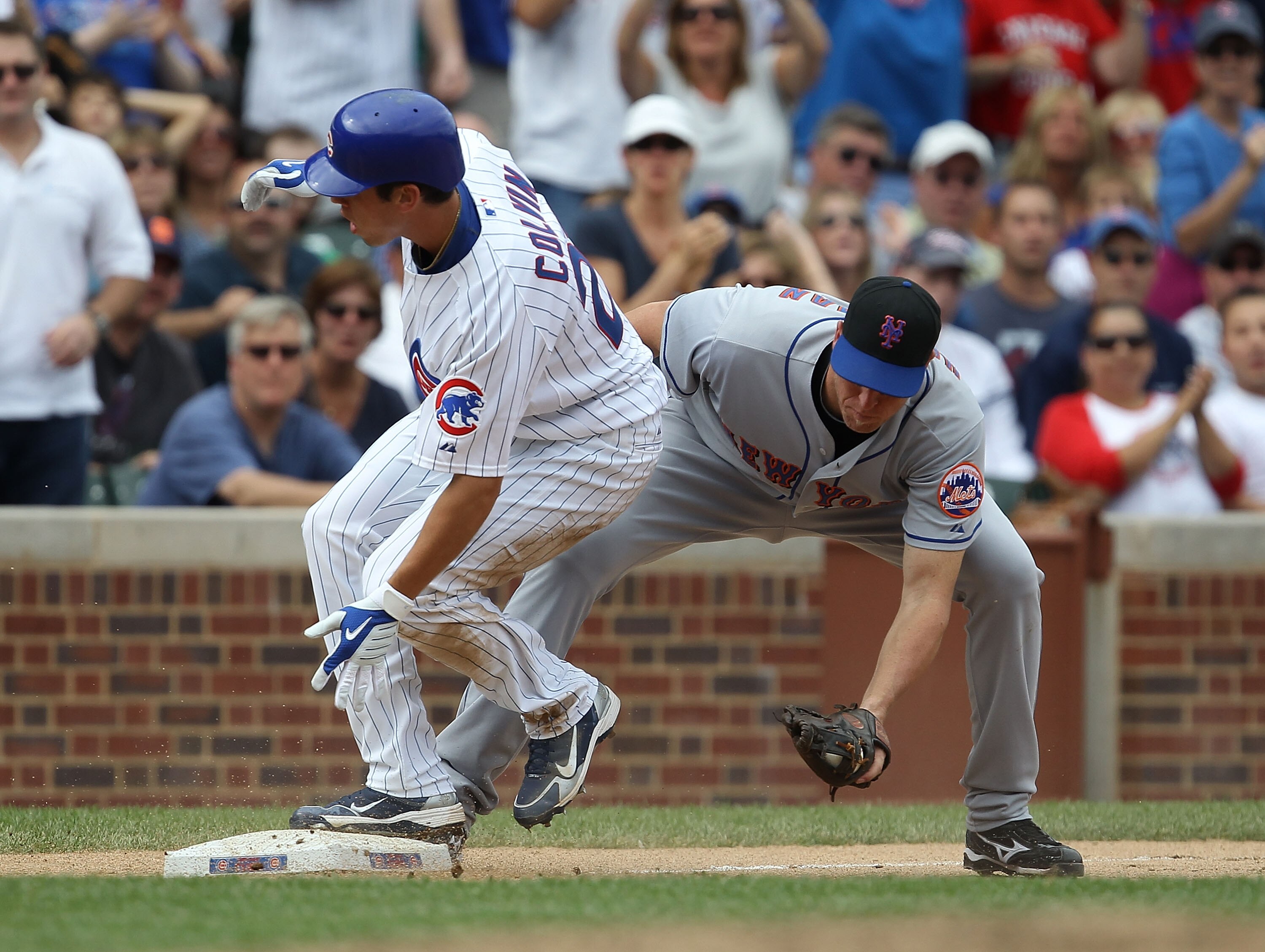CHICAGO - SEPTEMBER 05: Tyler Colvin #21 of the Chicago Cubs makes it to 3rd base ahead of the tag by Mike Hessman #19 of the New York Mets for a triple in the 4th inning at Wrigley Field on September 5, 2010 in Chicago, Illinois. (Photo by Jonathan Danie