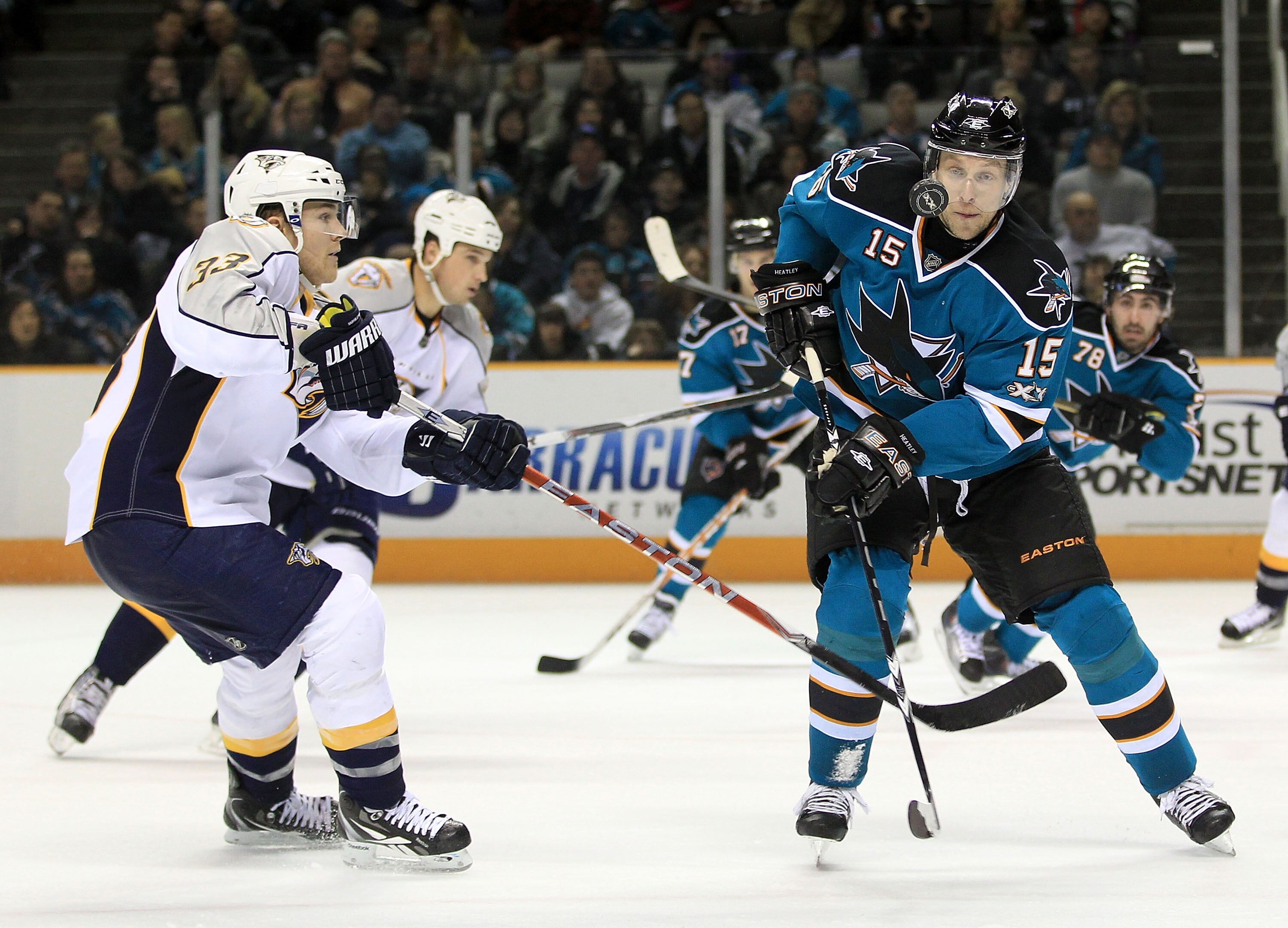 SAN JOSE, CA - JANUARY 08:  Colin Wilson #33 of the Nashville Predators and Dany Heatley #15 of the San Jose Sharks go for the puck at HP Pavilion on January 8, 2011 in San Jose, California.  (Photo by Ezra Shaw/Getty Images)