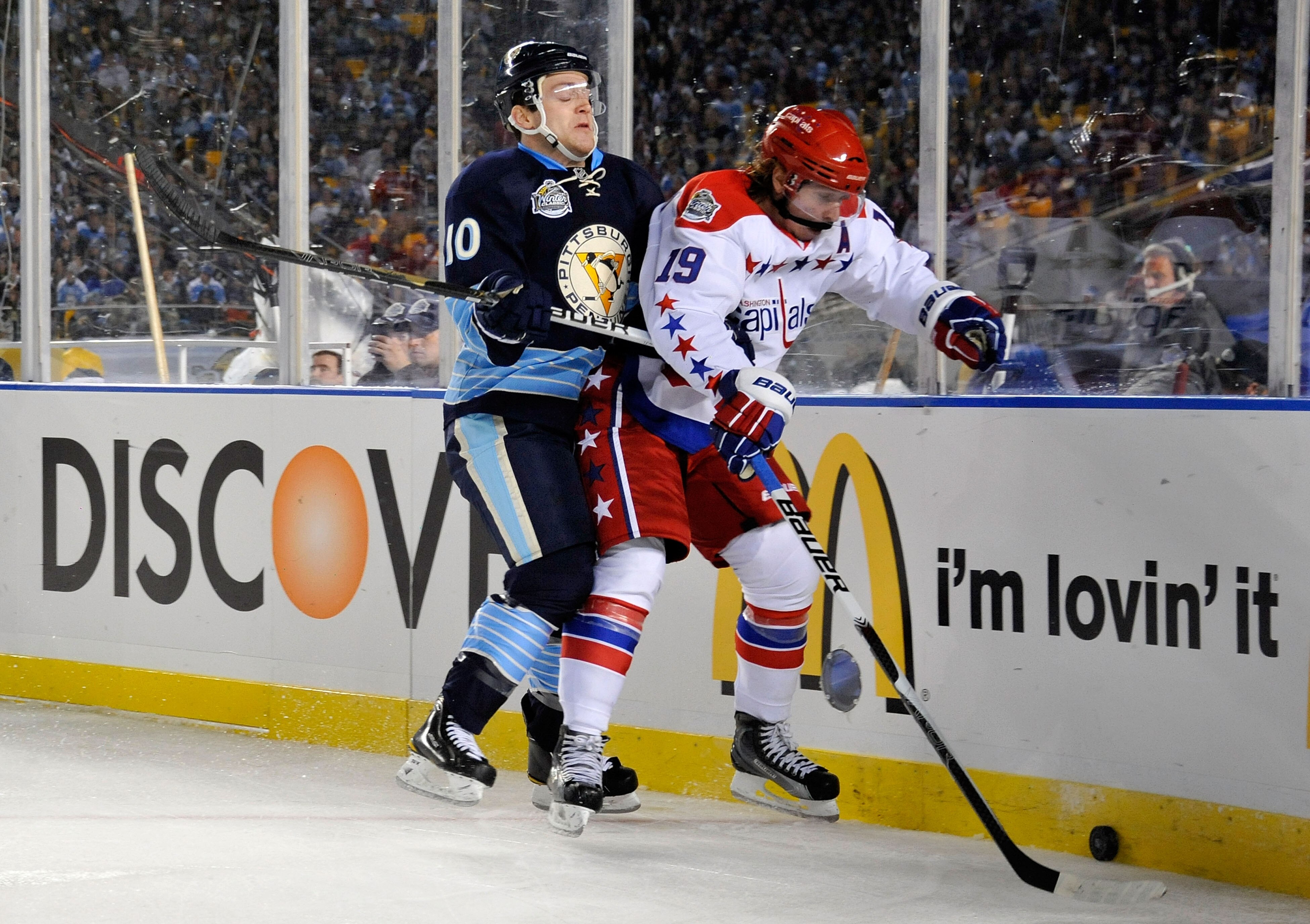 PITTSBURGH, PA - JANUARY 01:  Nicklas Backstrom #19 of the Washington Capitals battles for the puck against Mark Letestu #10 of the Pittsburgh Penguins during the 2011 NHL Bridgestone Winter Classic at Heinz Field on January 1, 2011 in Pittsburgh, Pennsyl