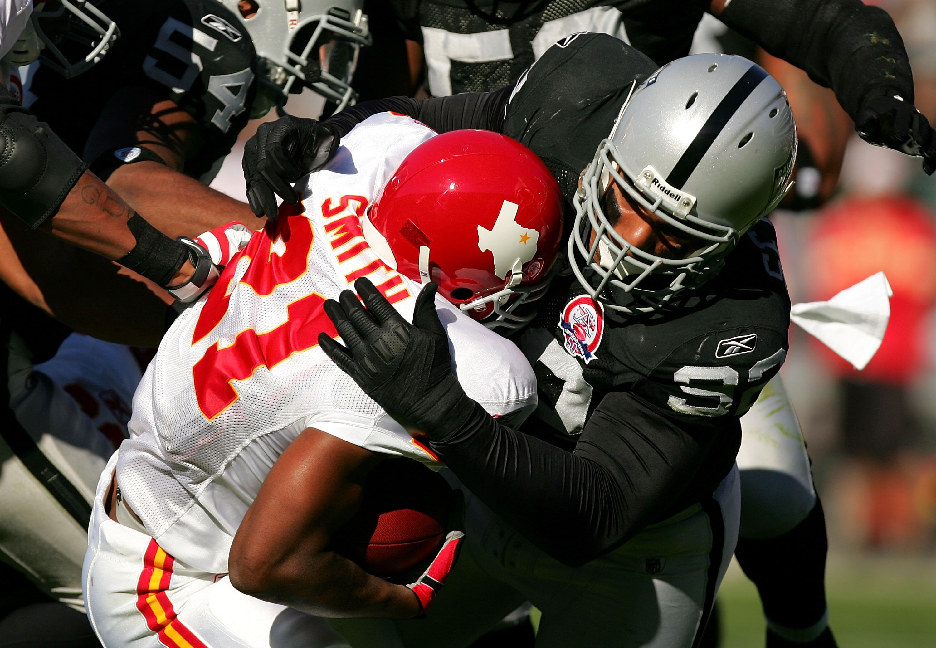OAKLAND, CA - NOVEMBER 15:  Richard Seymour #92 of the Oakland Raiders tackles Kolby Smith #21 of the Kansas City Chiefs at Oakland-Alameda County Coliseum on November 15, 2009 in Oakland, California.  (Photo by Ezra Shaw/Getty Images)