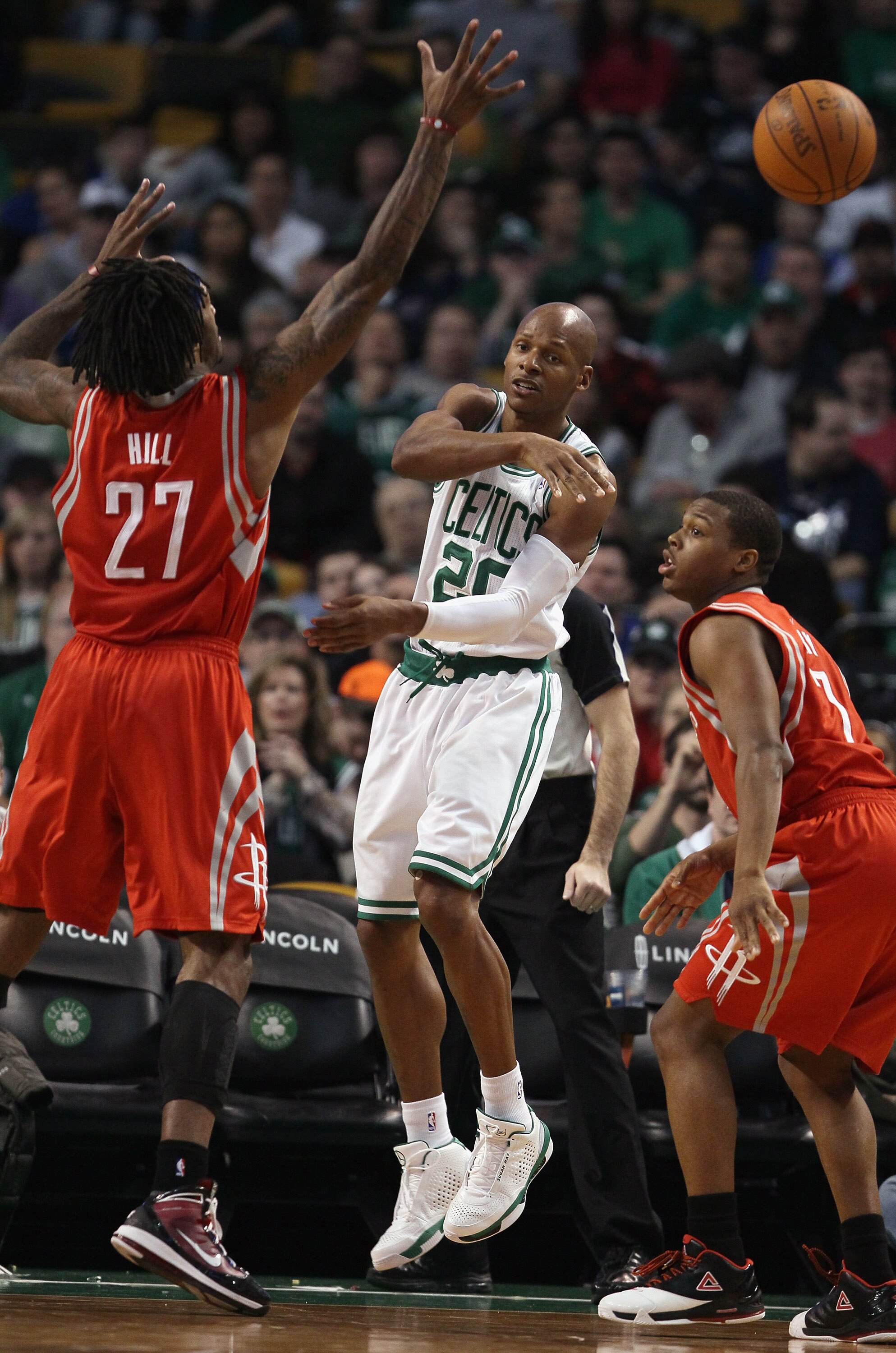 BOSTON, MA - JANUARY 10:  Ray Allen #20 of the Boston Celtics passes the ball as Kyle Lowry #7 and Jordan Hill #27 of the Houston Rockets defend on January 10, 2011 at the TD Garden in Boston, Massachusetts.  The Rockets defeated the Celtics 108-102. NOTE
