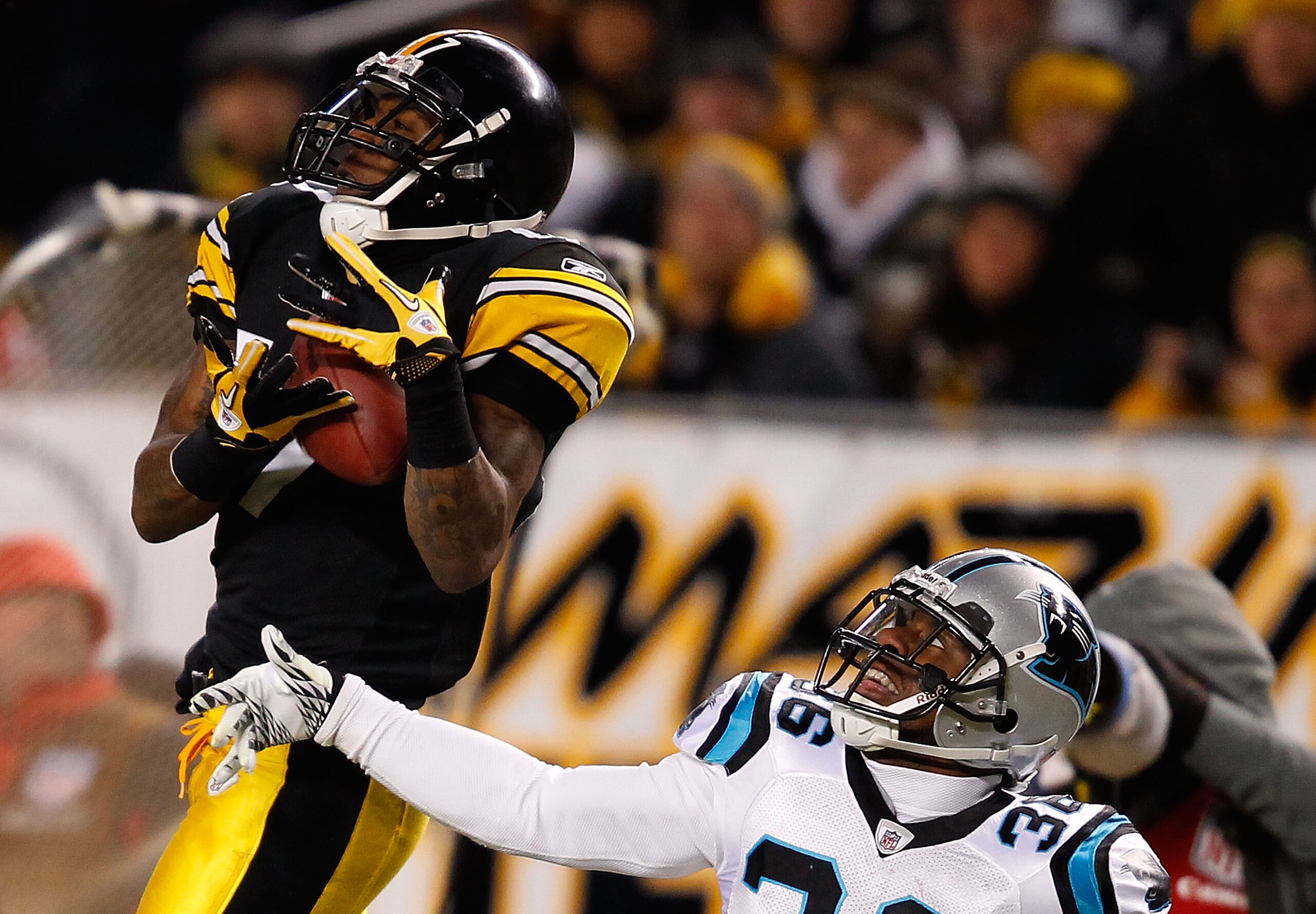 PITTSBURGH - DECEMBER 23:  Mike Wallace #17 of the Pittsburgh Steelers catches a pass in front of Robert McClain #36 of the Carolina Panthers during the game on December 23, 2010 at Heinz Field in Pittsburgh, Pennsylvania.  (Photo by Jared Wickerham/Getty